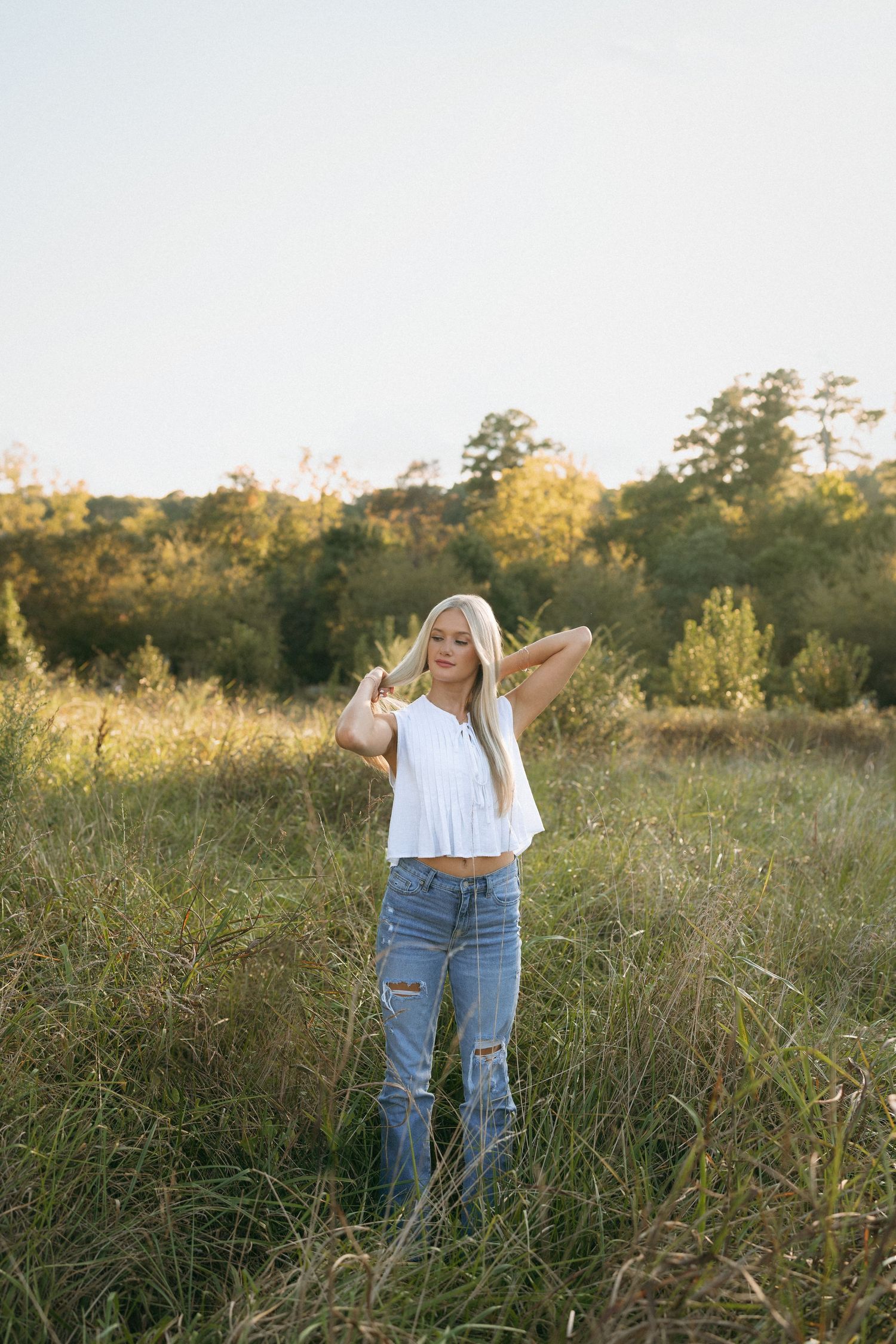 High school senior girl portrait in warm evening light at Historic Yates Mill County Park in Raleigh.