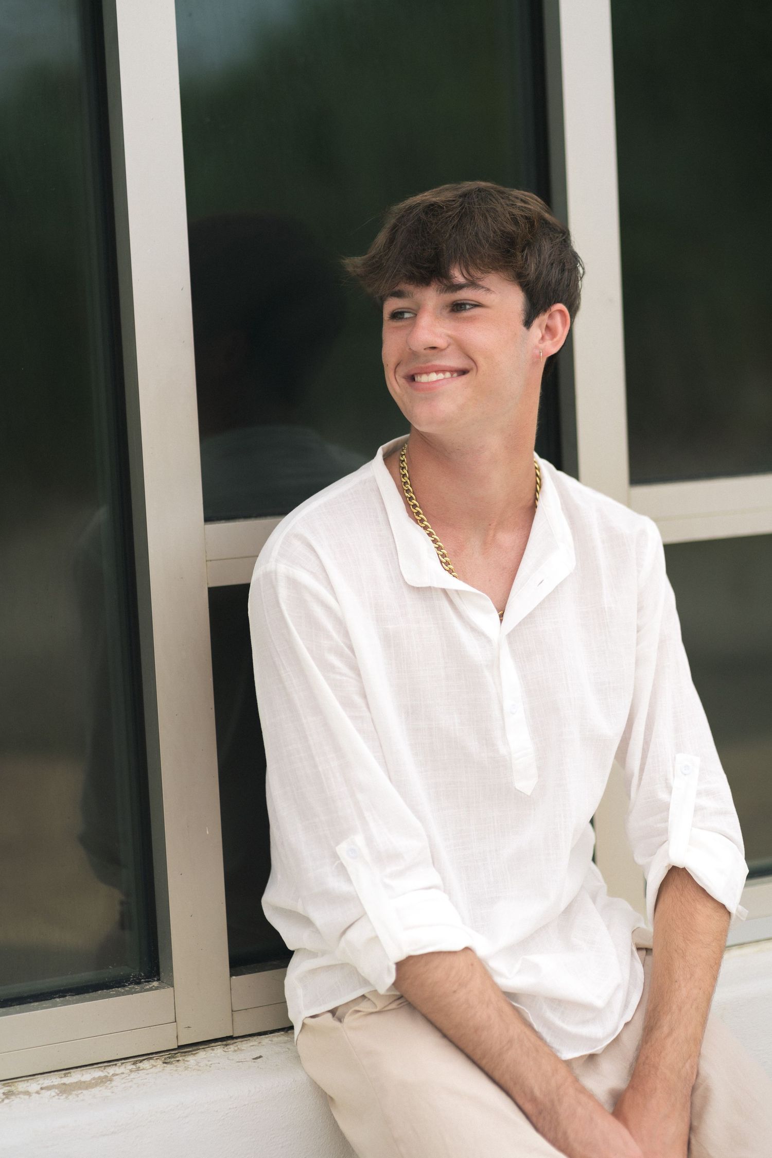 Senior boy in khakis and white shirt photographed at Oak Island Beach, NC