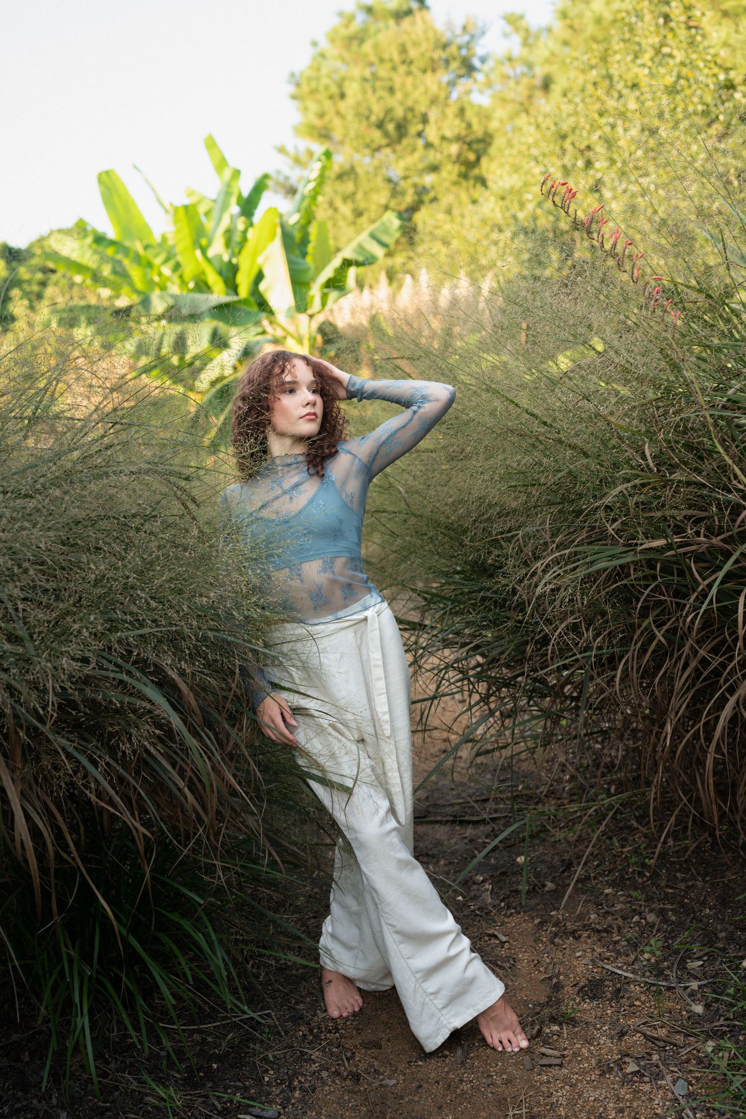 High school senior dancer performing a pose at JC Raulston Arboretum in Raleigh.