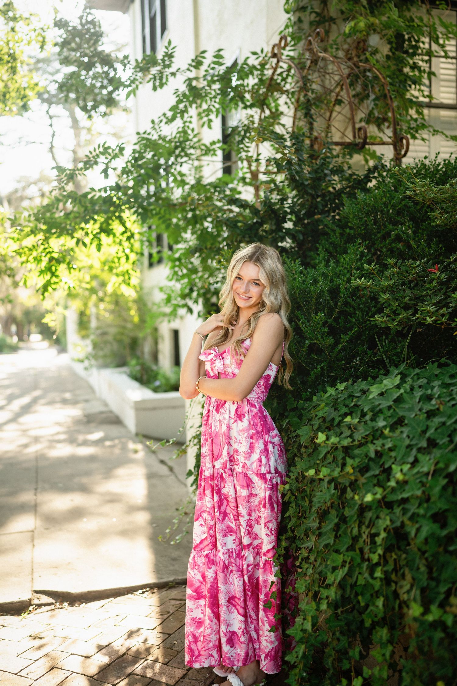 Senior photo of Sydney in front of a stunning residence in Wilmington, NC, draped with Spanish moss.
