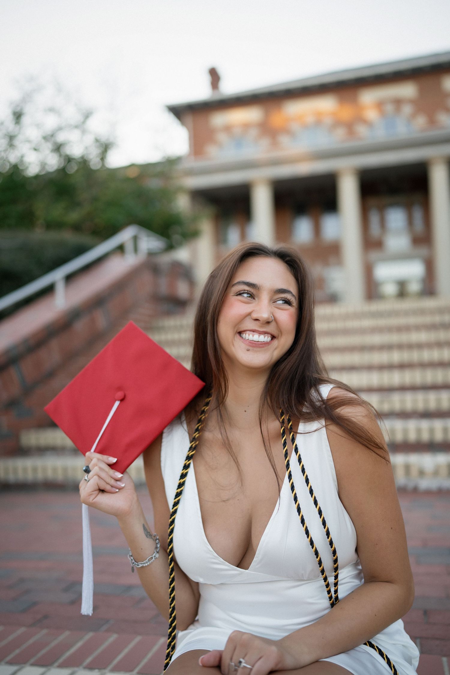 NC State graduate in red cap and gown at the Court of Carolina in Raleigh, NC