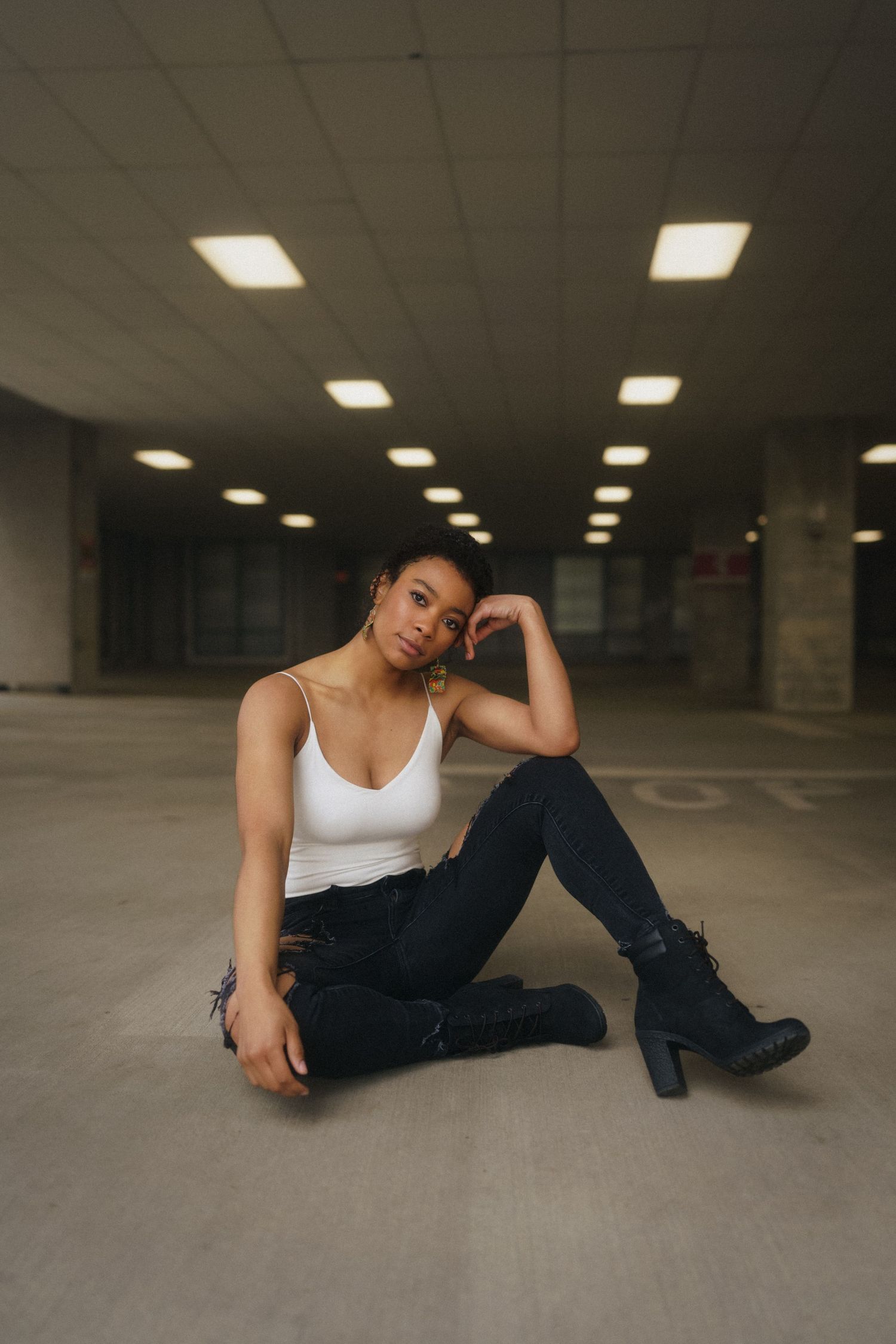High school senior girl sitting on a parking deck in downtown Raleigh, North Carolina.