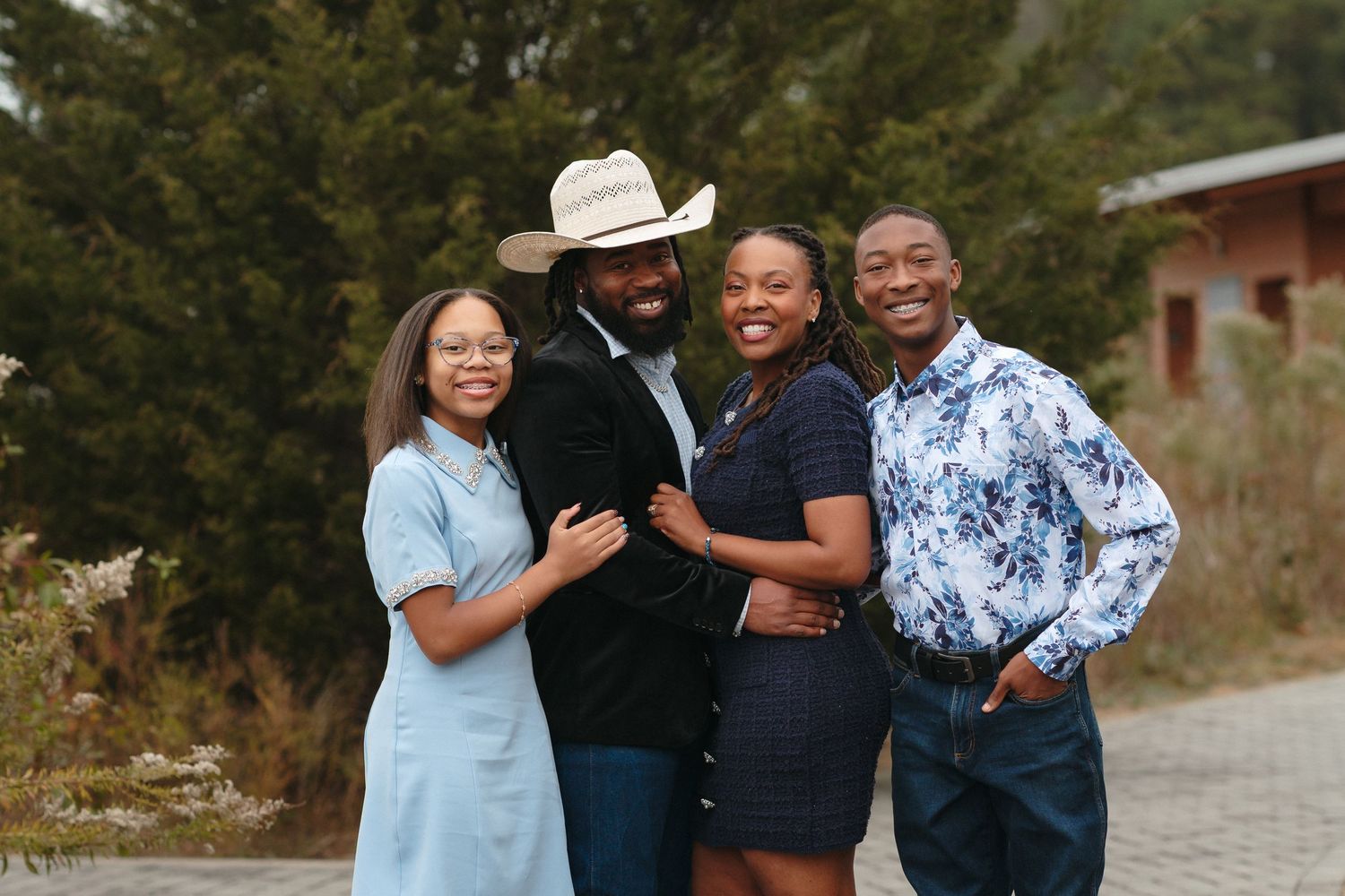 Family of four posing together during outdoor session at Horseshoe Farm Preserve in North Carolina