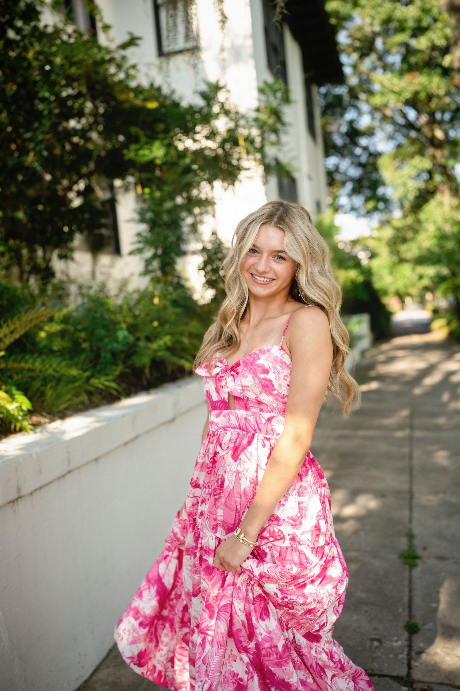 Senior photo of Sydney in front of a stunning residence in Wilmington, NC, draped with Spanish moss.