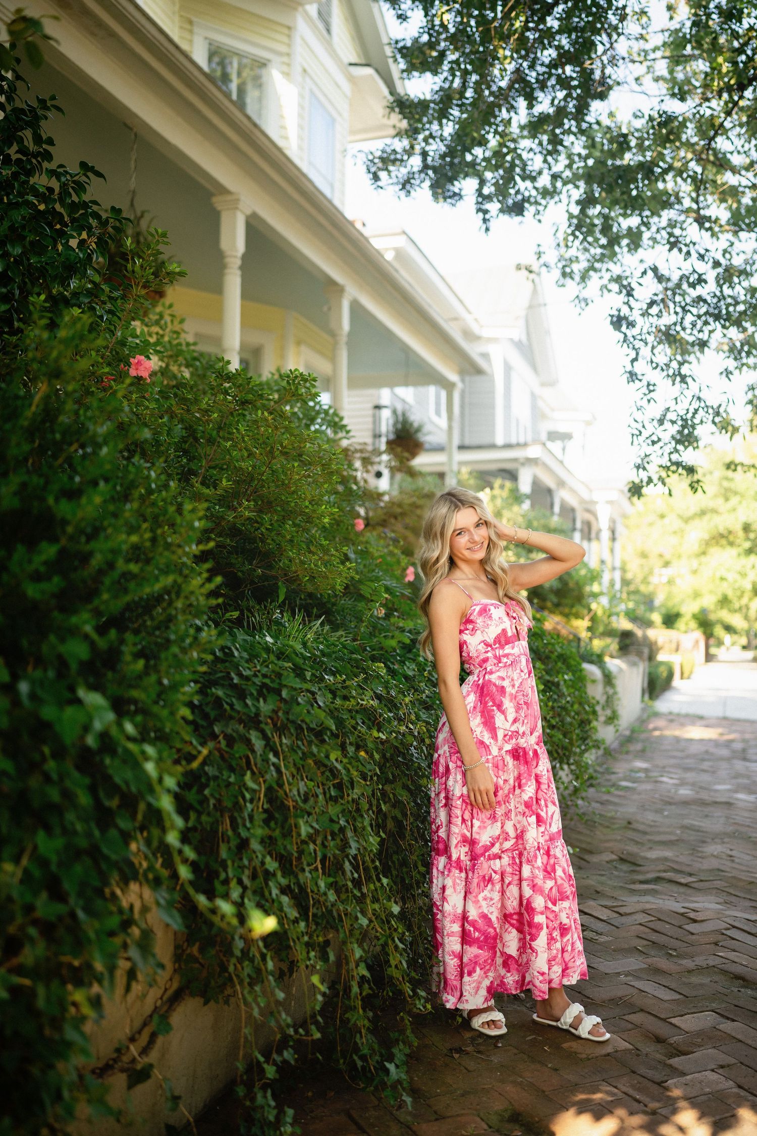 Senior photo of Sydney in front of a stunning residence in Wilmington, NC