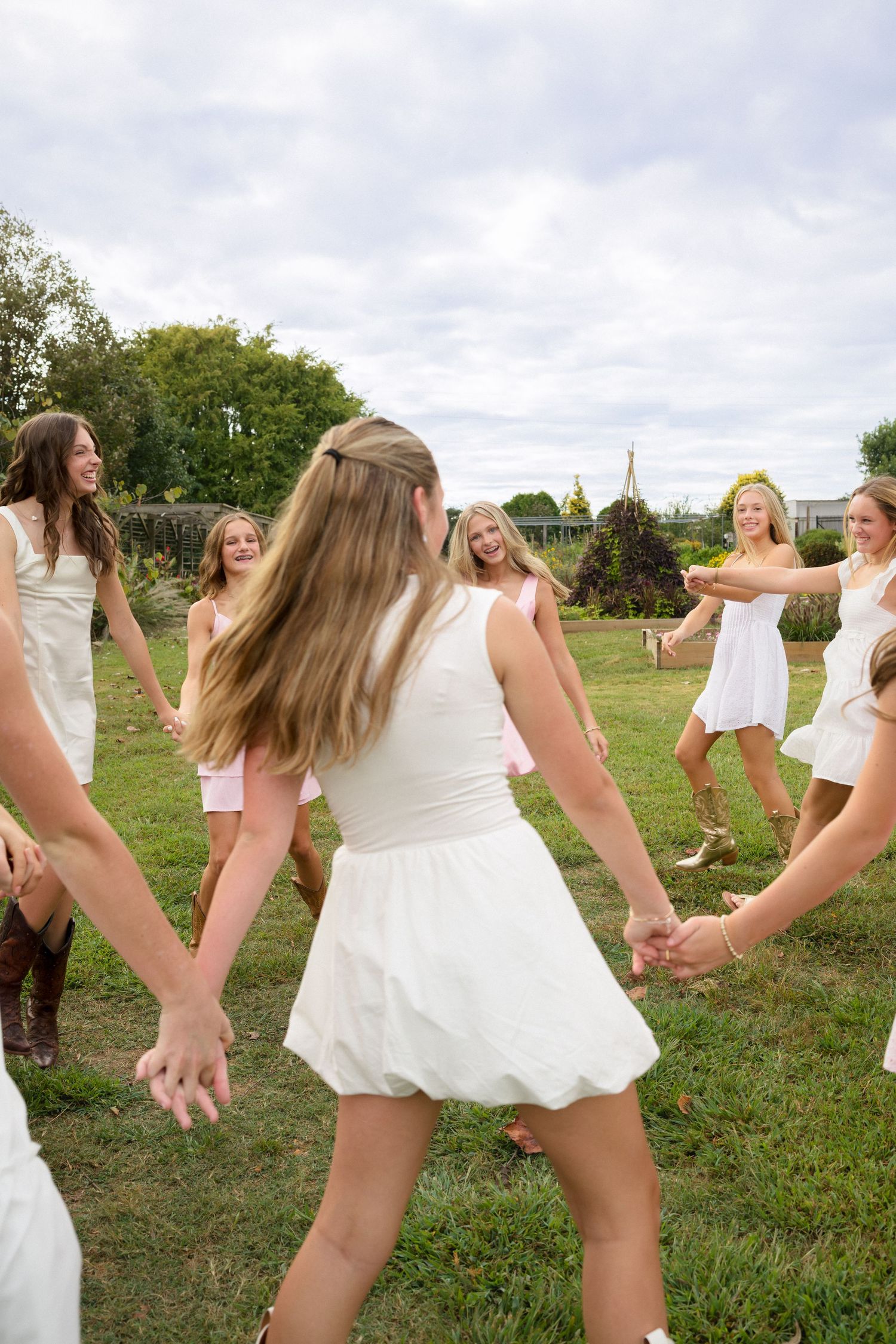 Friends walking together during a garden photo session in Raleigh
