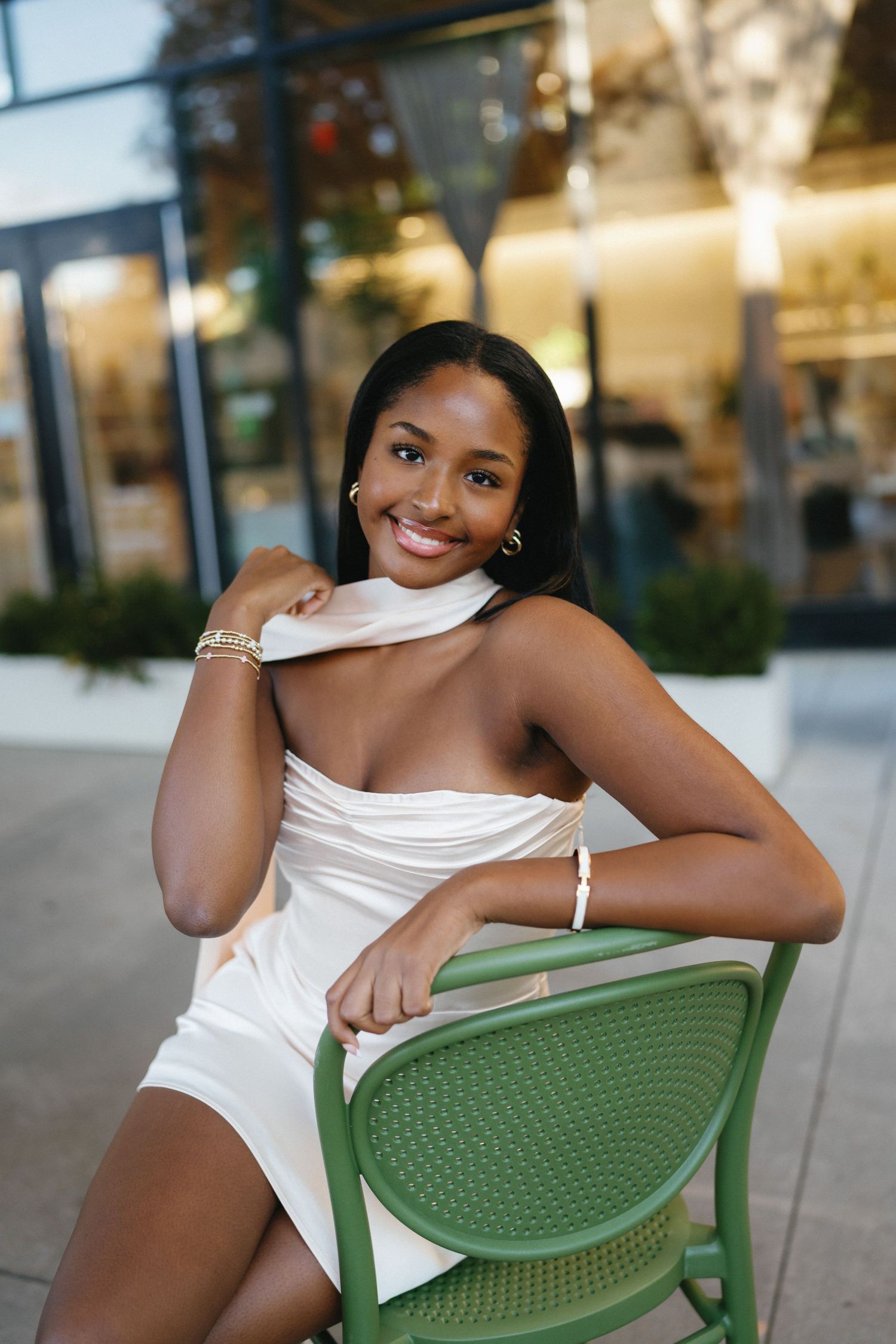 High school senior in a white dress photographed in downtown Raleigh, North Carolina