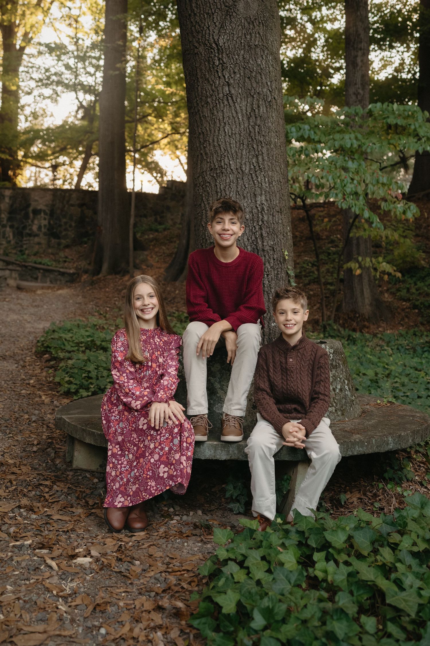 Siblings sitting together  during a mini session at the Raleigh rose garden