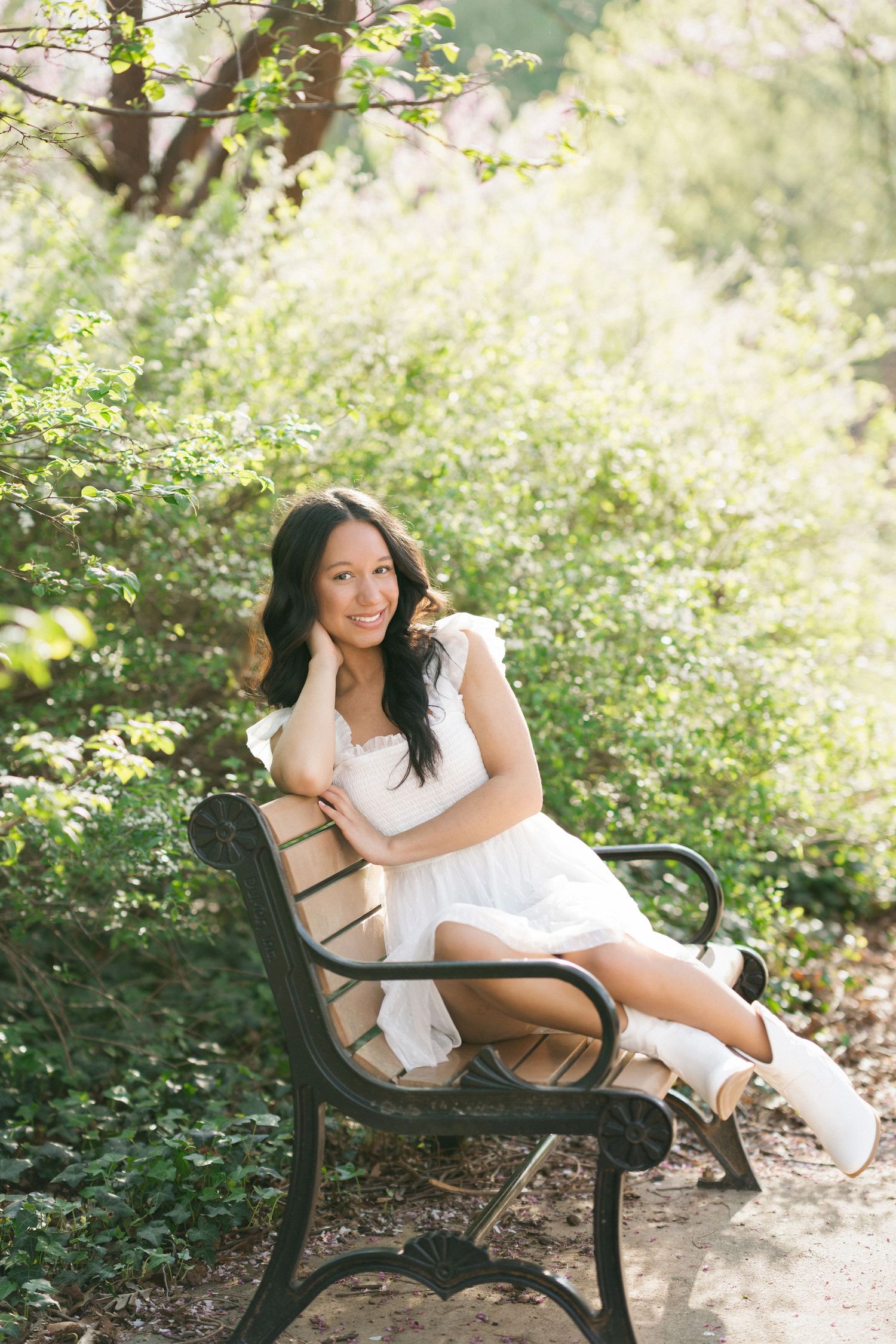 High school senior girl sitting on a bench at Fred Fletcher Park in Raleigh, North Carolina.