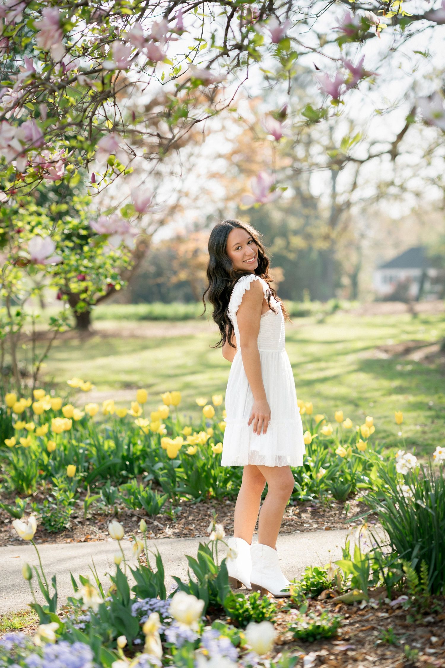 High school senior girl standing in tulips at Fred Fletcher Park in Raleigh, North Carolina.