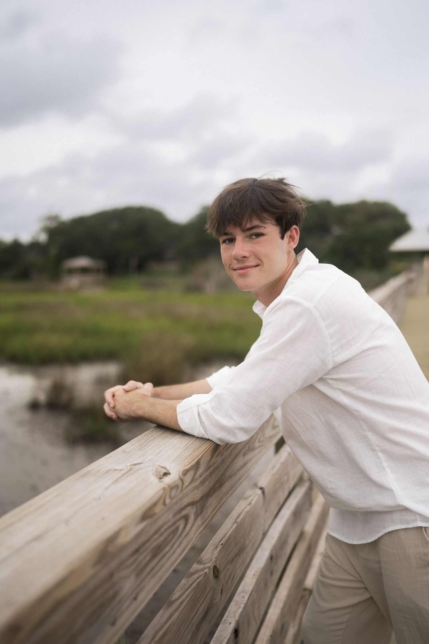 Coastal senior portrait session on dock in Oak Island, NC