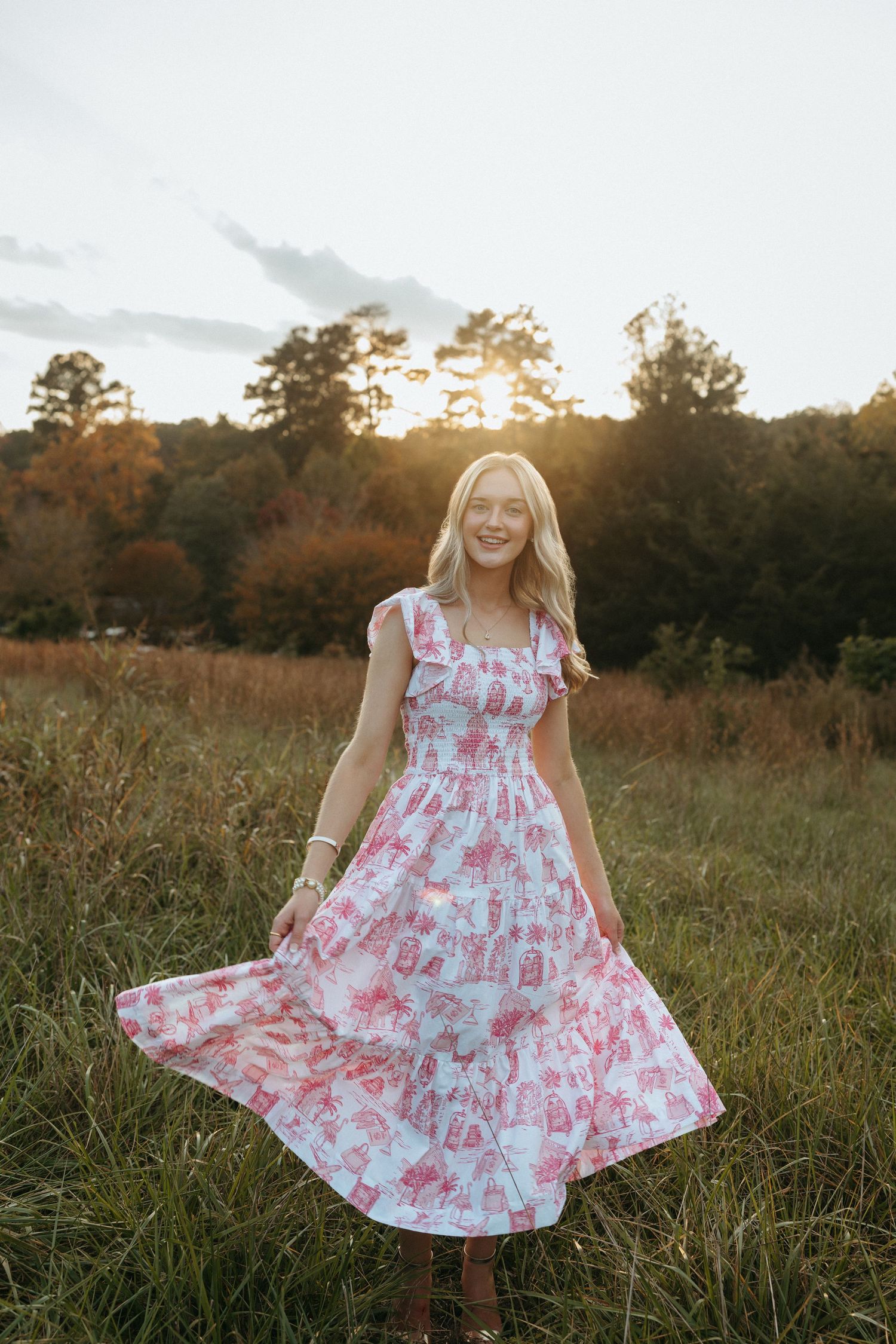 High school senior girl twirling in a dress at Historic Yates Mill County Park in Raleigh, North Carolina.