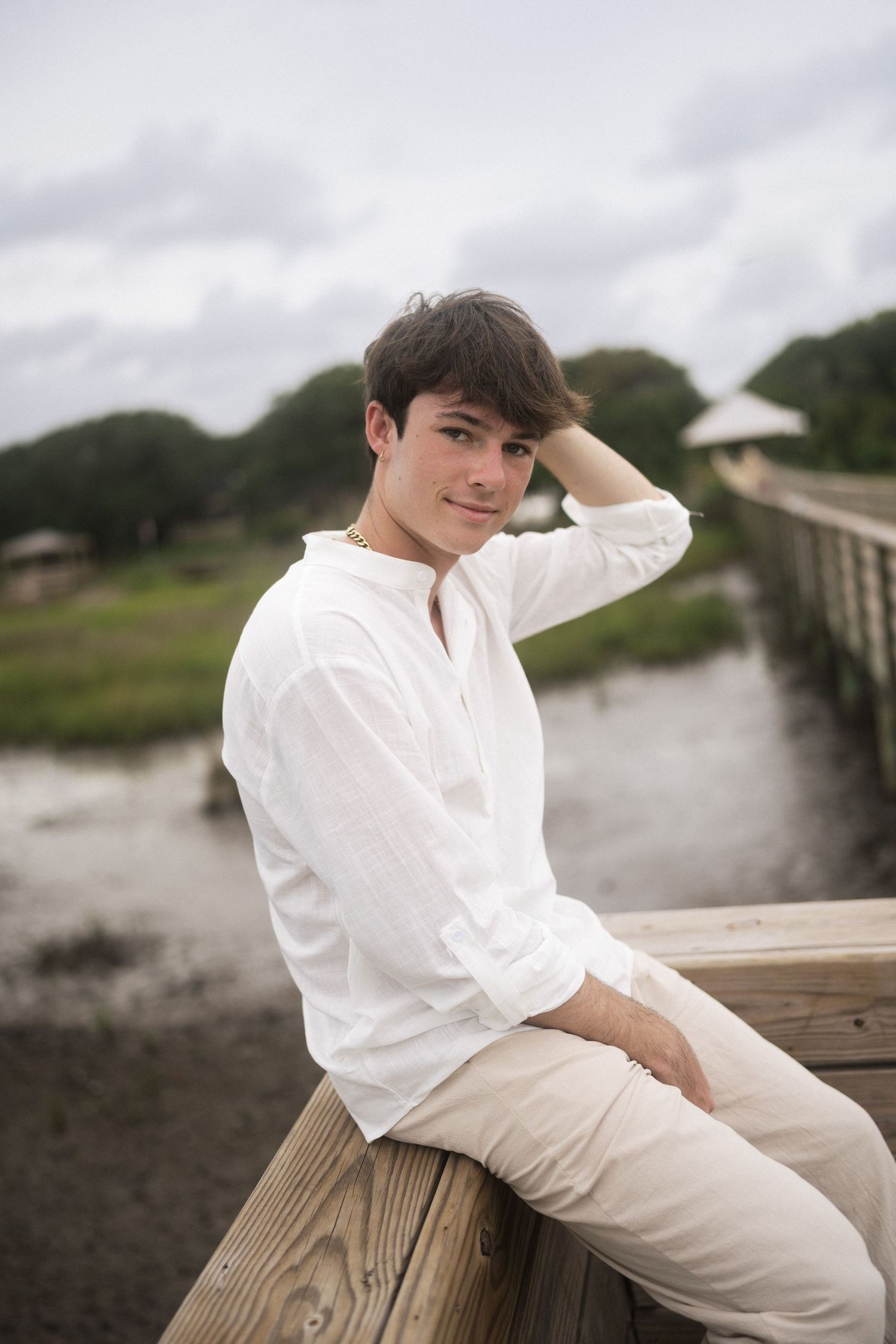 Coastal senior portrait session on dock in Oak Island, NC