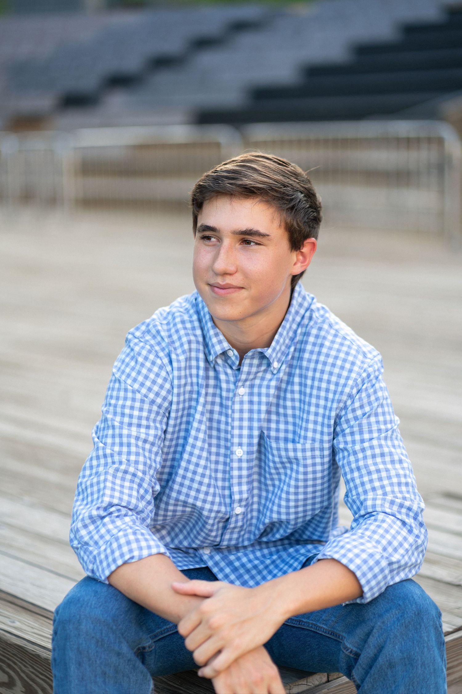 Close-up portrait smiling in a blue checkered shirt at NCMA senior session