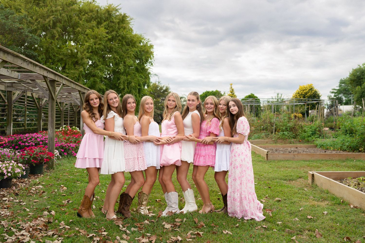 Friends posing together during a garden birthday session