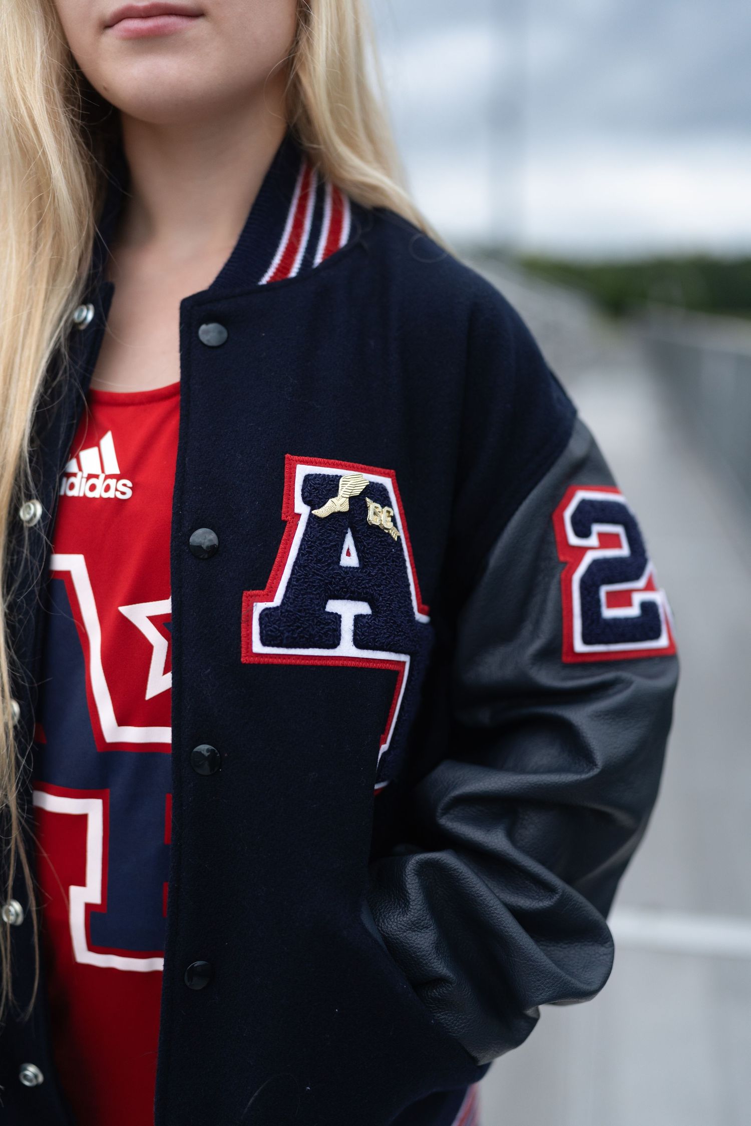 Close-up of a high school senior girl's letterman jacket at Apex Friendship High School track.