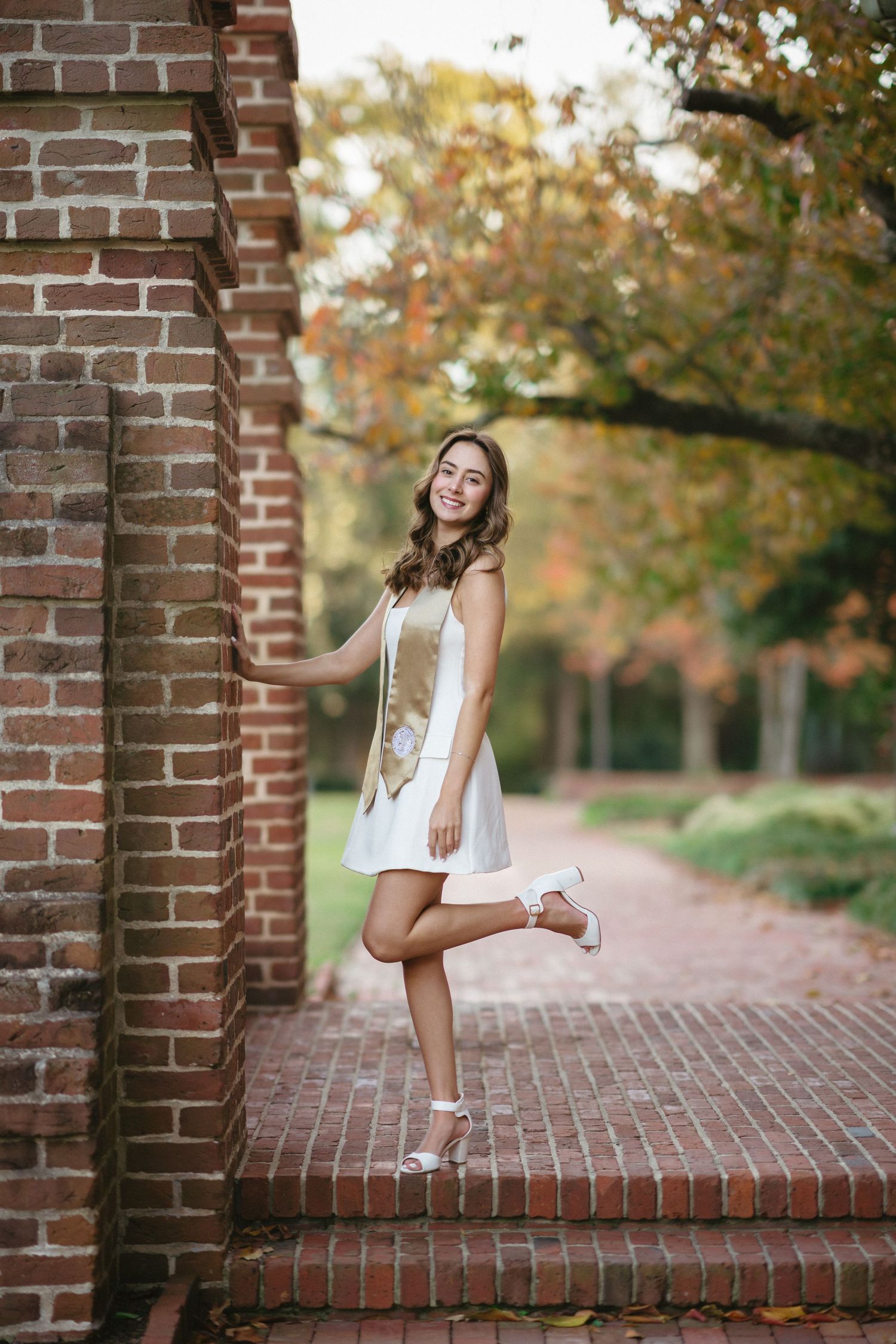 NC State college graduate wearing gold honors stole on campus in Raleigh