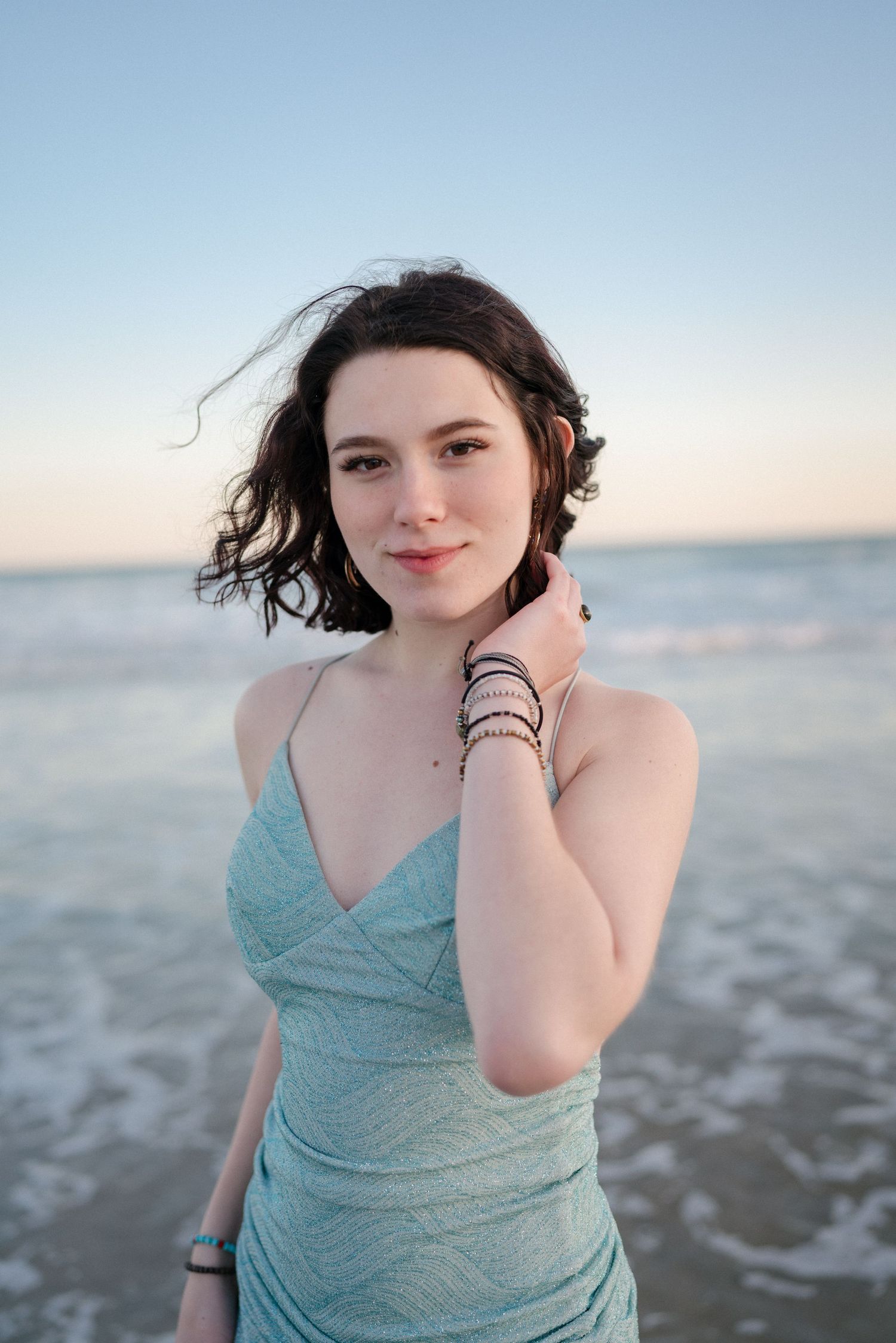 Close-up of a high school senior girl looking away in the ocean at Surf City, North Carolina.