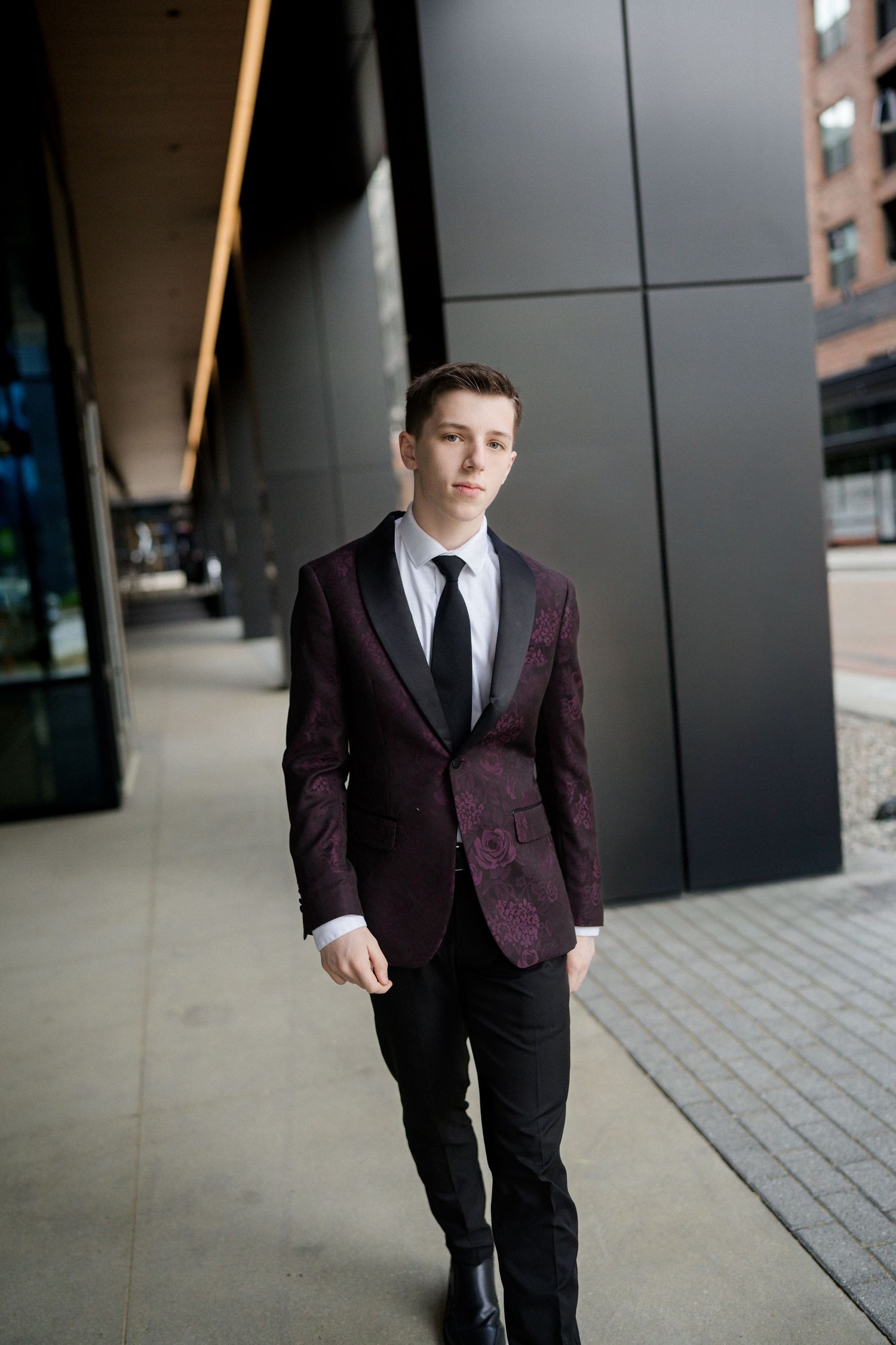 High school senior guy in black and purple suit photographed in downtown Raleigh