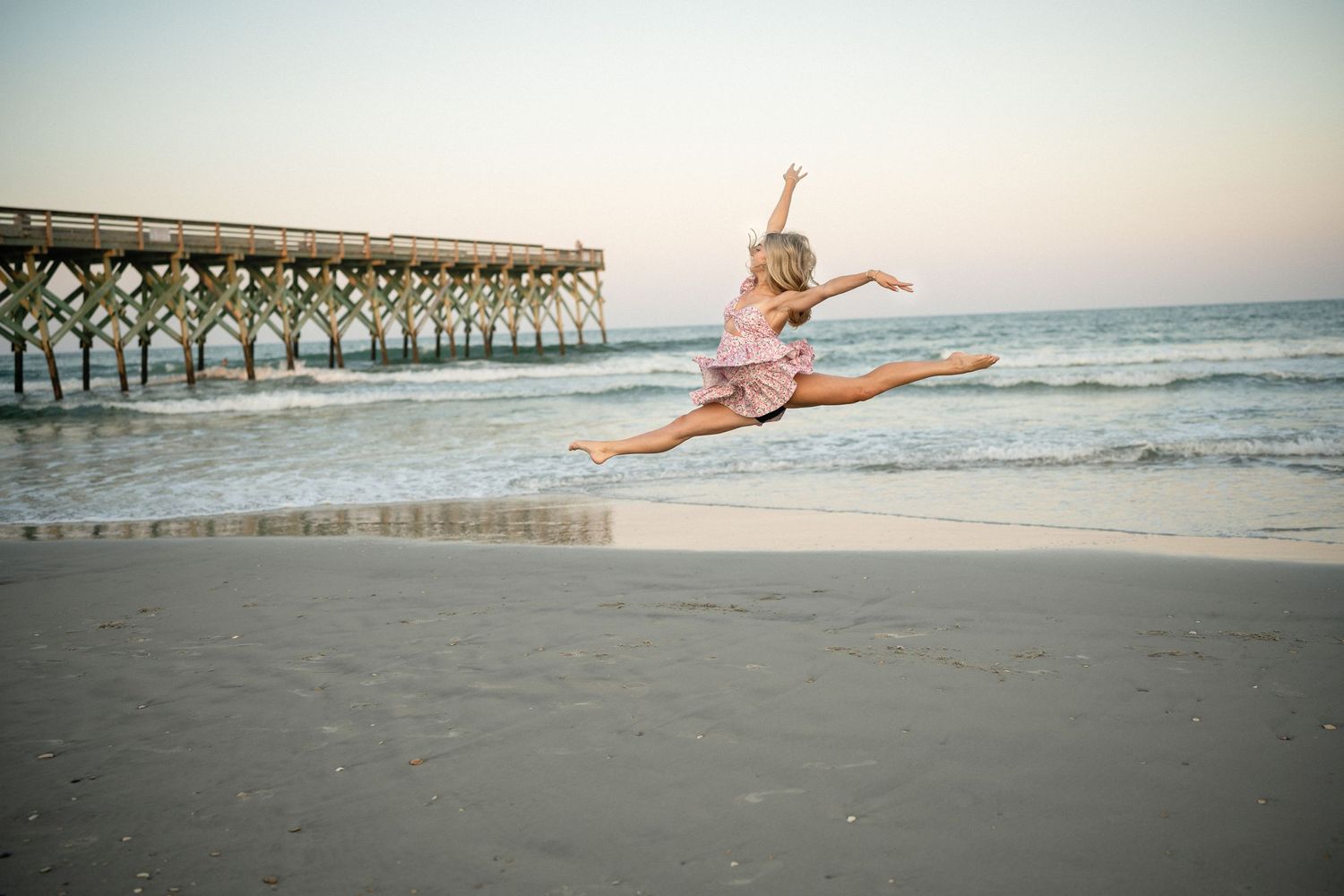Sydney dancing on Wilmington, NC beach, senior photo session with the ocean in the background