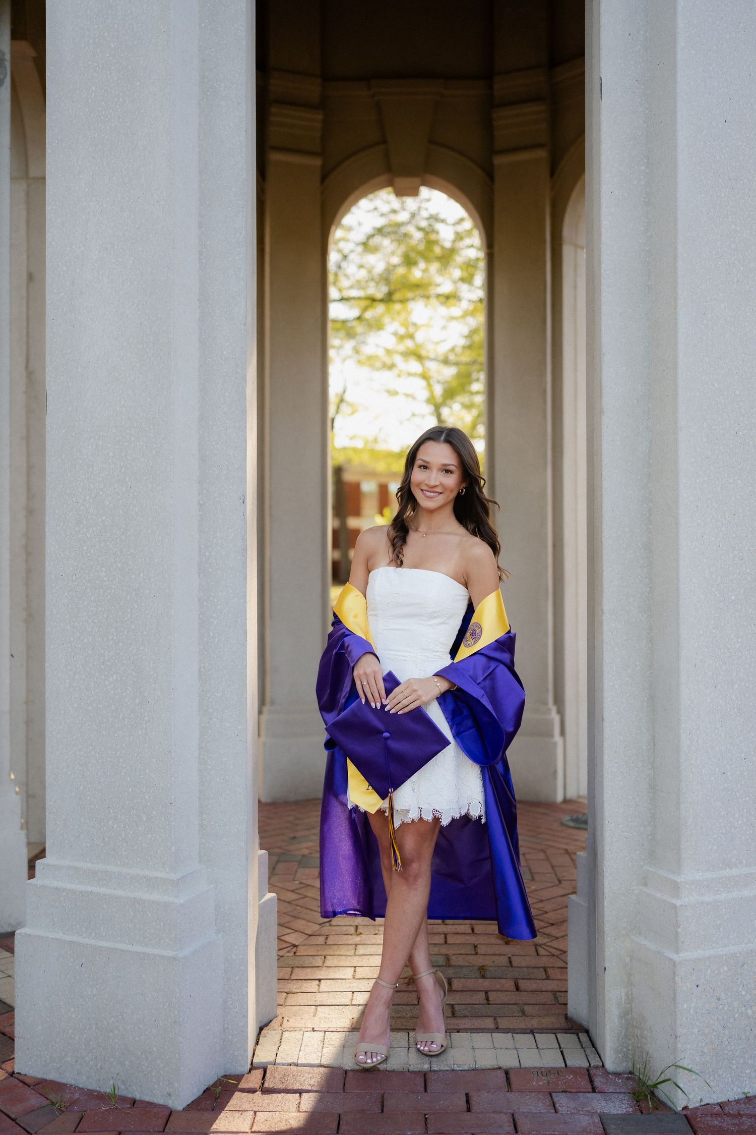 College graduate in cap and gown at the Cupola on East Carolina University campus in Greenville, NC