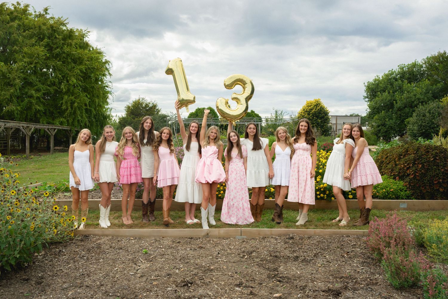 Friends posing together during a garden birthday session