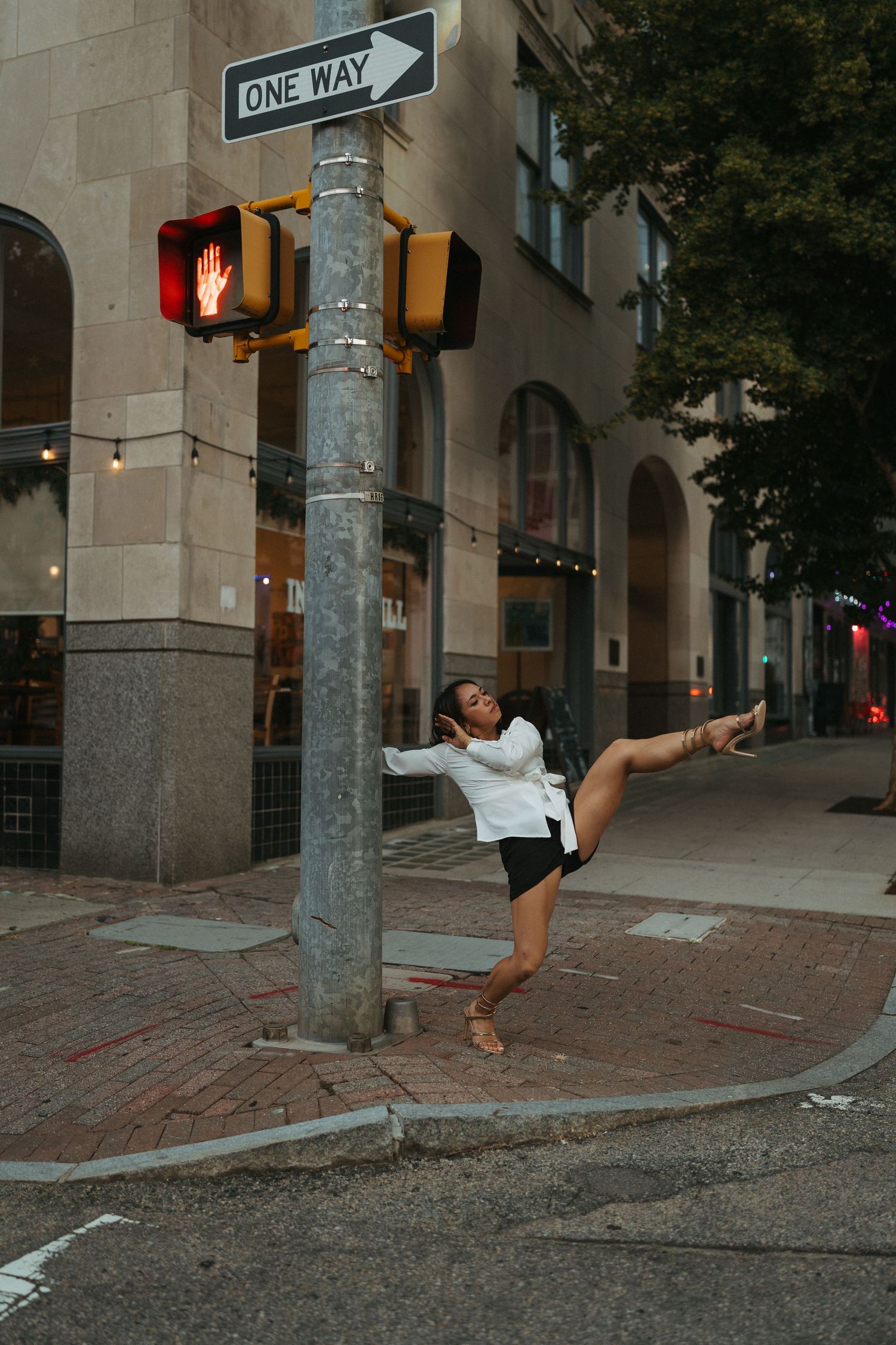 College dancer posing on a pole on Salisbury Street in downtown Raleigh.