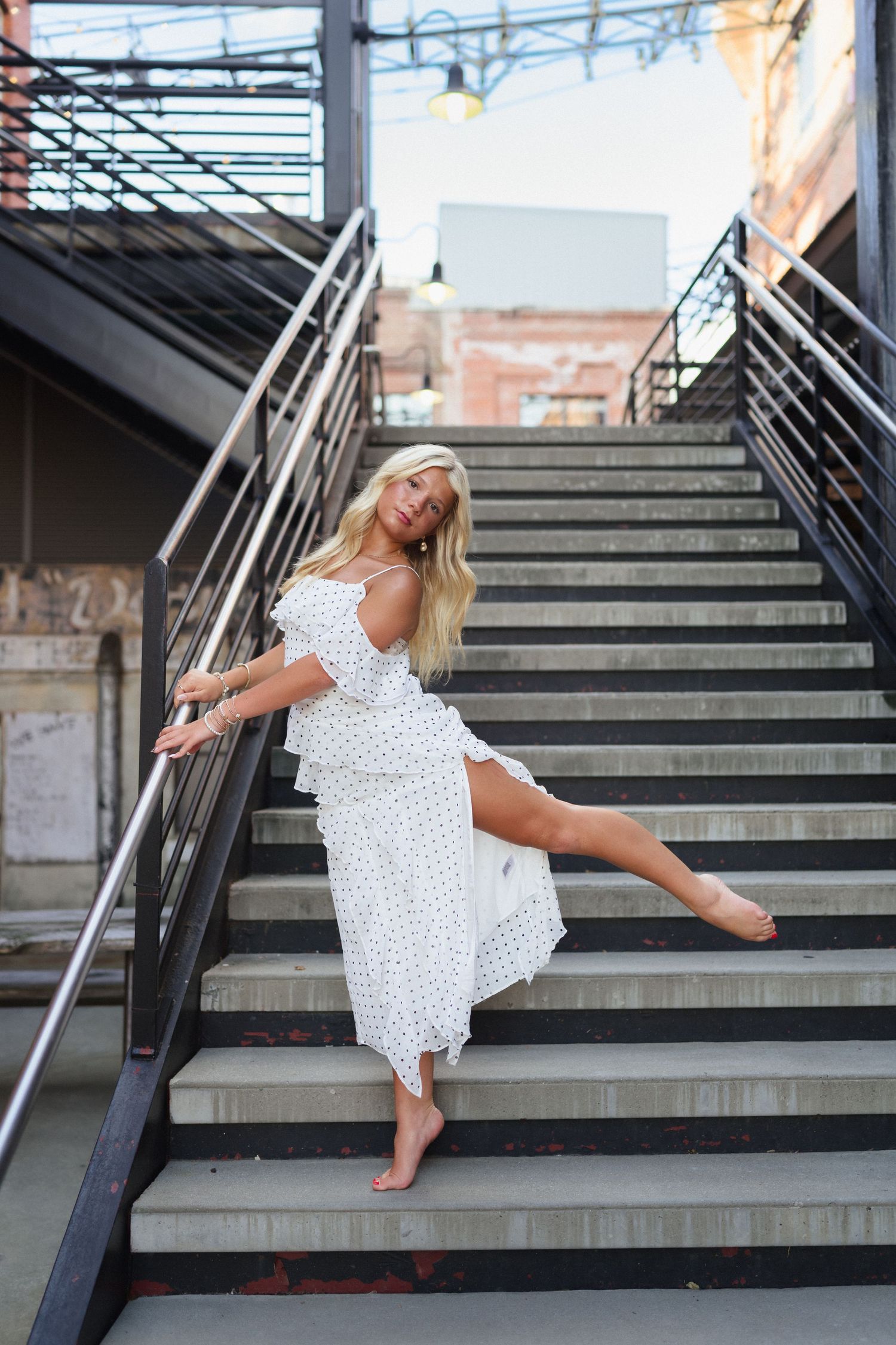 High school senior dancer posing on stairs at American Tobacco Campus in Durham, North Carolina.