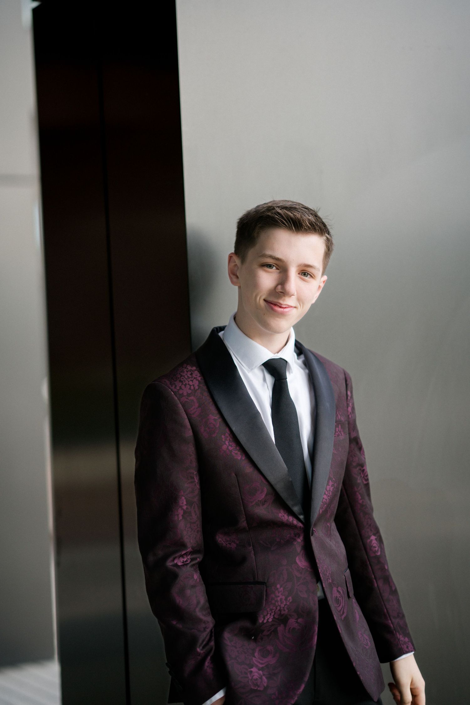 Senior boy portrait in black and purple suit at Smoky Hollow in Raleigh