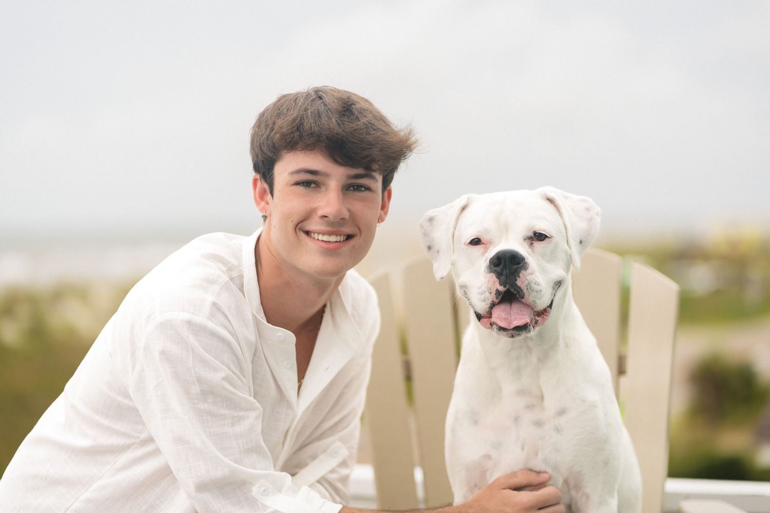 Senior boy portrait with dog at Oak Island Beach, NC