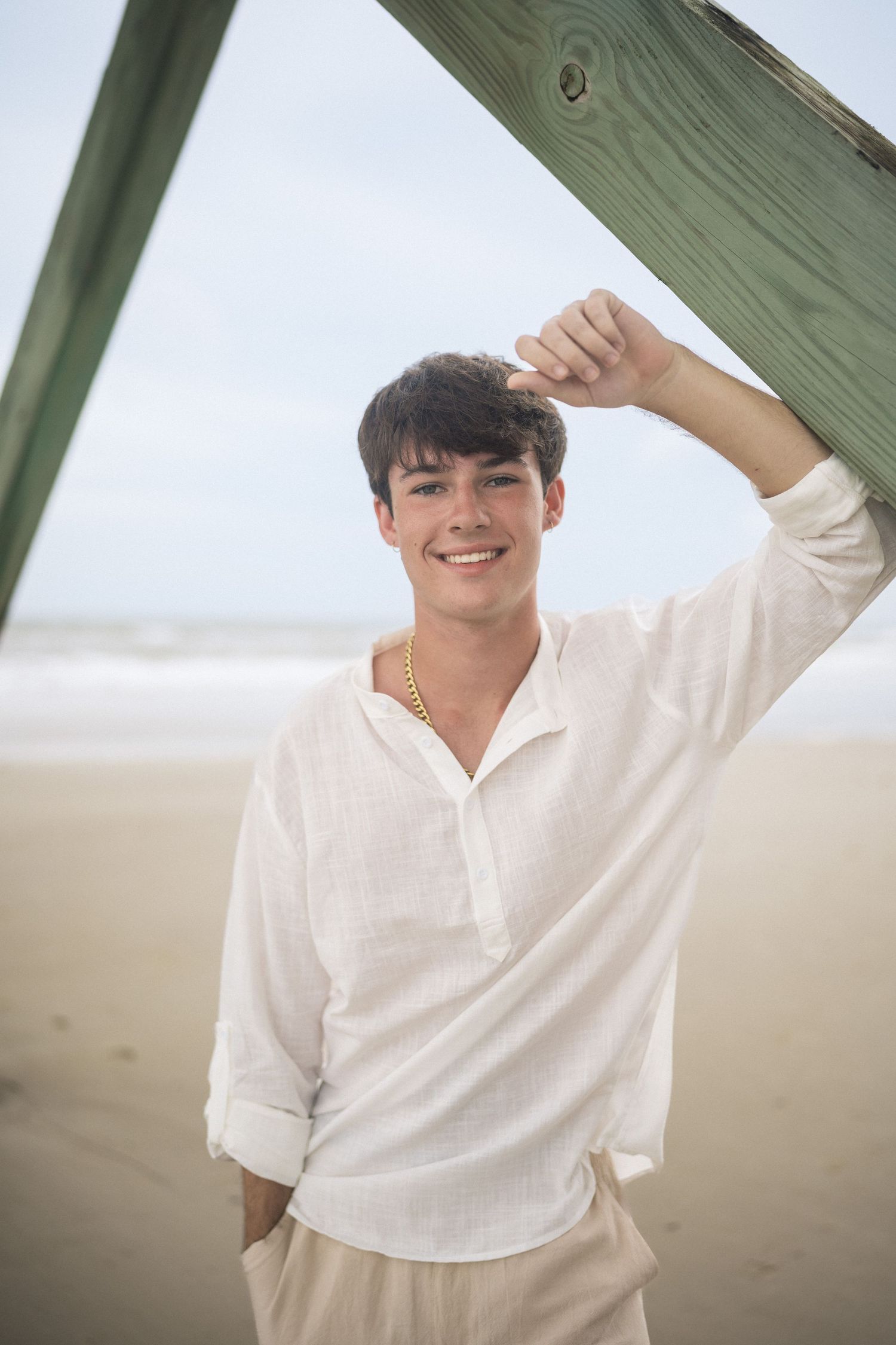 Relaxed coastal senior portrait for high school senior guy at Oak Island Beach