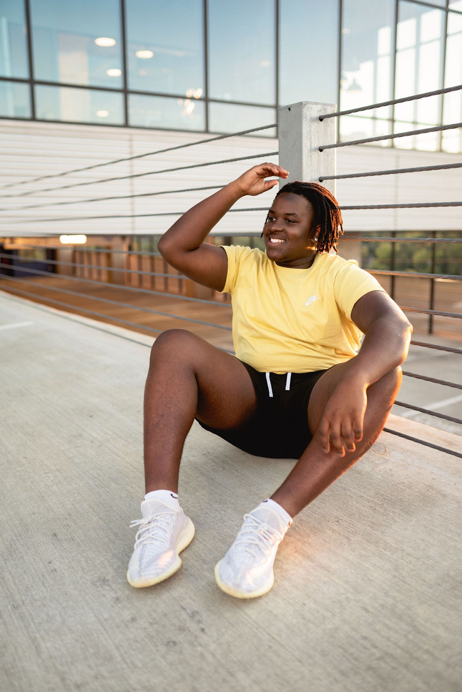 Confident high school senior guy photographed on rooftop in downtown Raleigh, NC