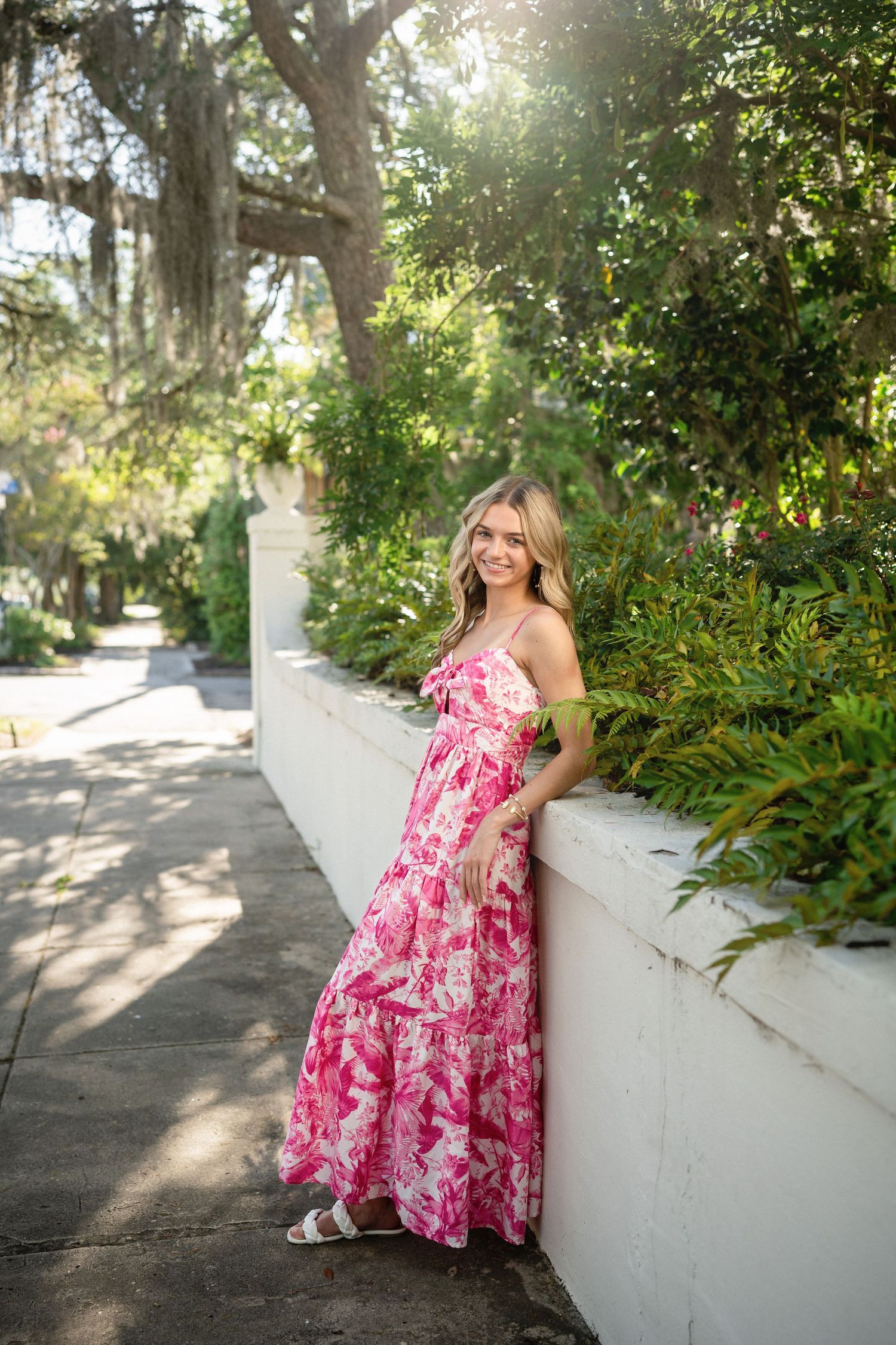 Senior photo of Sydney in front of a stunning residence in Wilmington, NC, draped with Spanish moss.