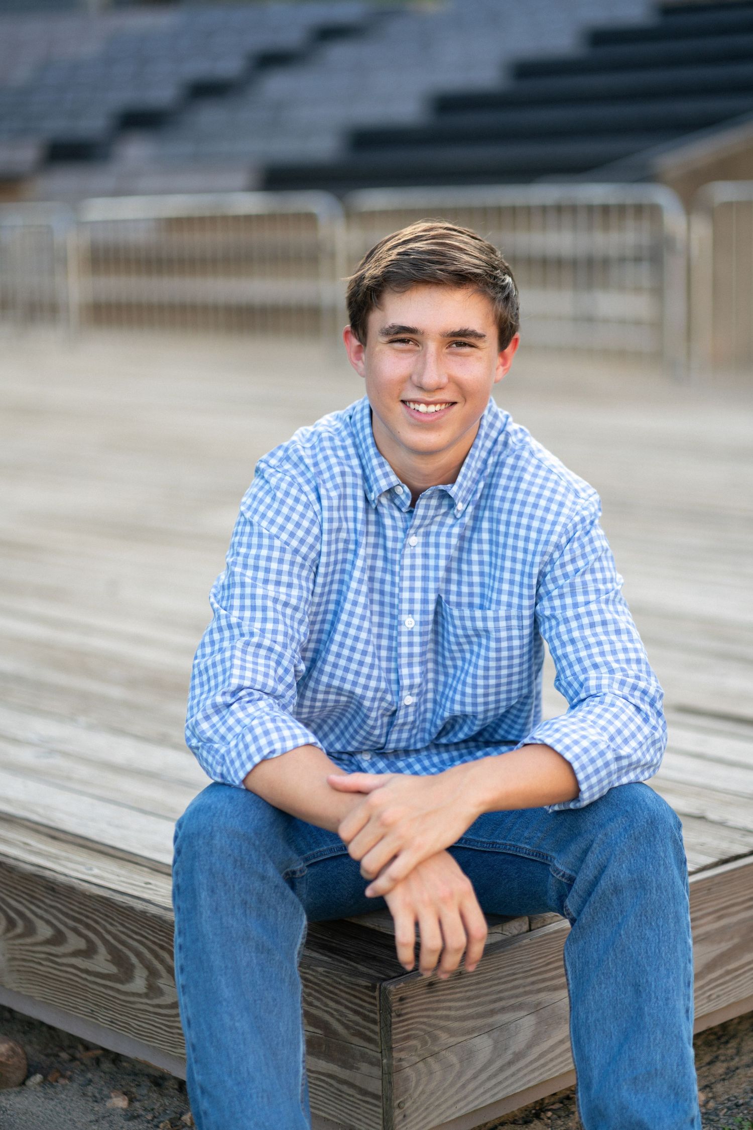Close-up portrait smiling in a blue checkered shirt at NCMA senior session
