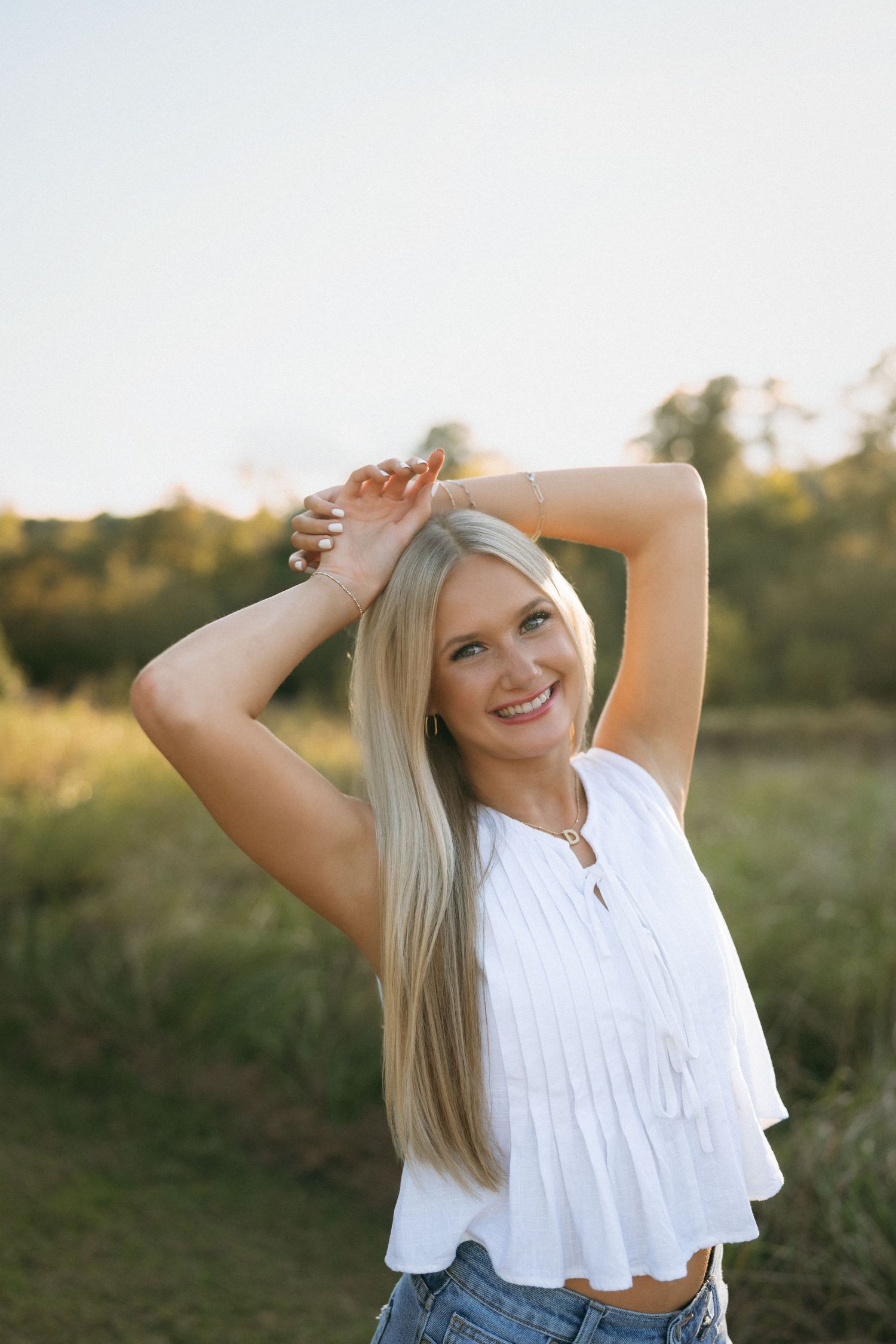 High school senior girl during a golden hour portrait session at Historic Yates Mill County Park in Raleigh, North Carolina.
