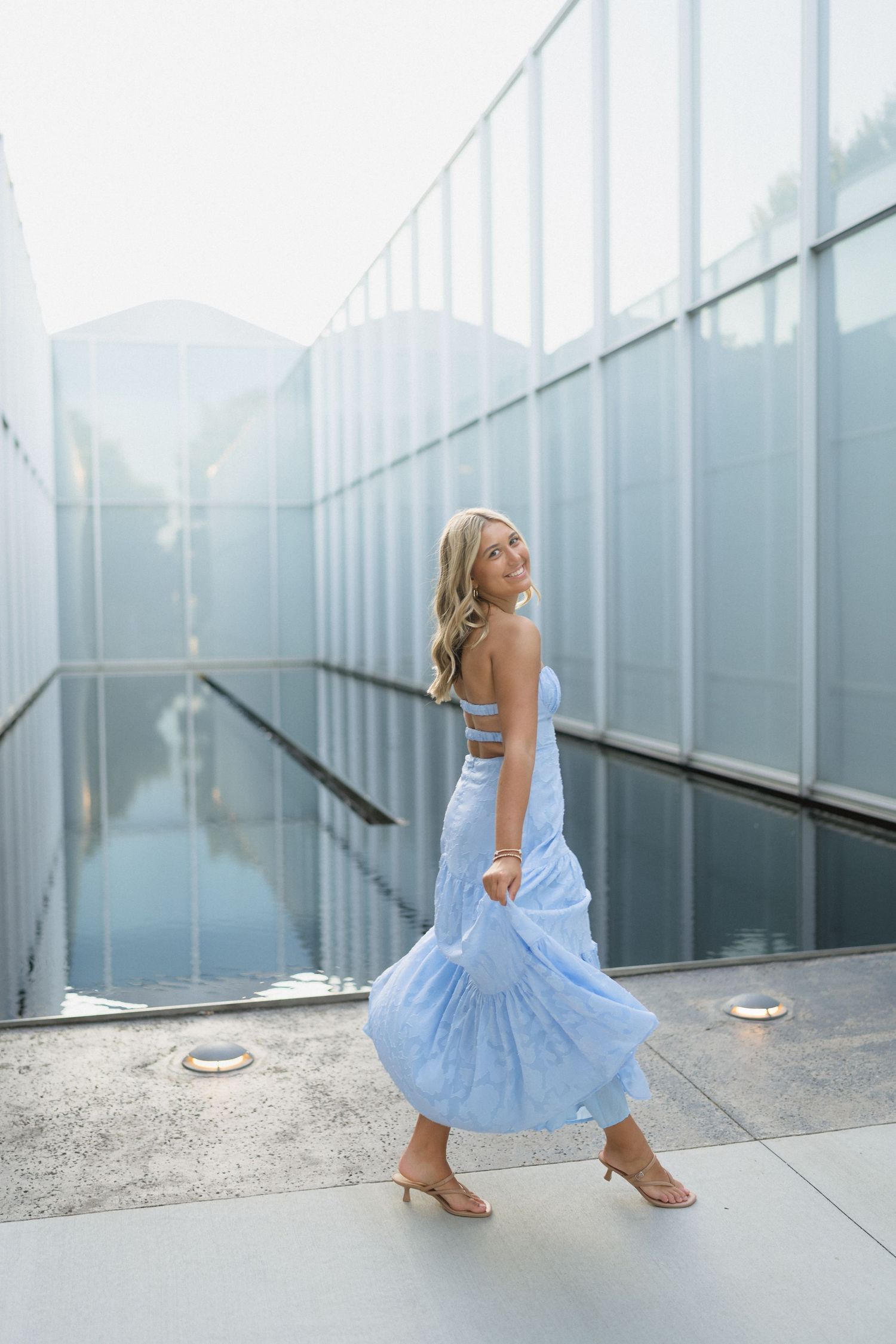 High school senior girl posing near a water feature at the North Carolina Museum of Art in Raleigh, North Carolina.