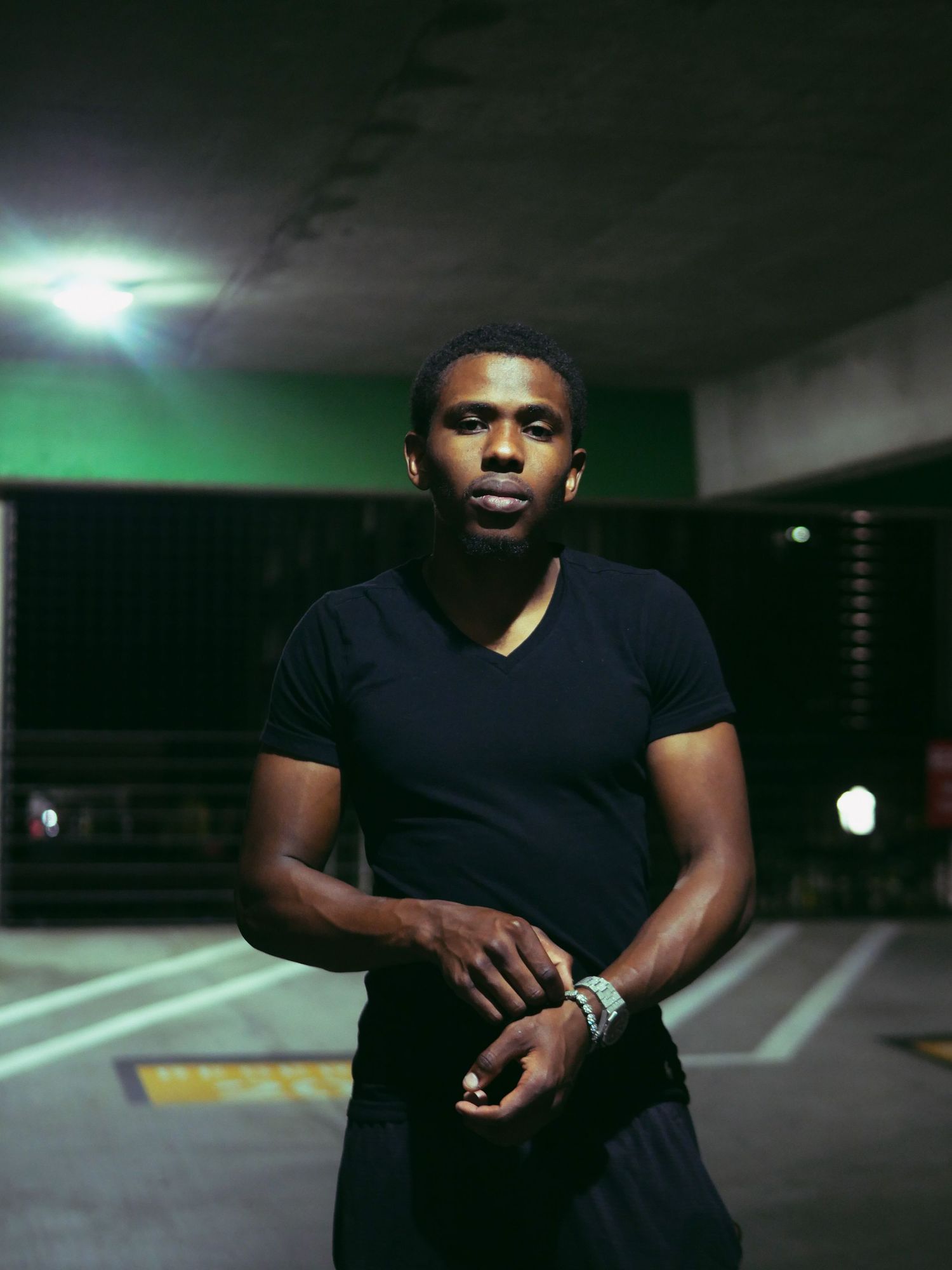 Dramatic low-light portraits in parking garage with moody lighting and dark atmosphere.