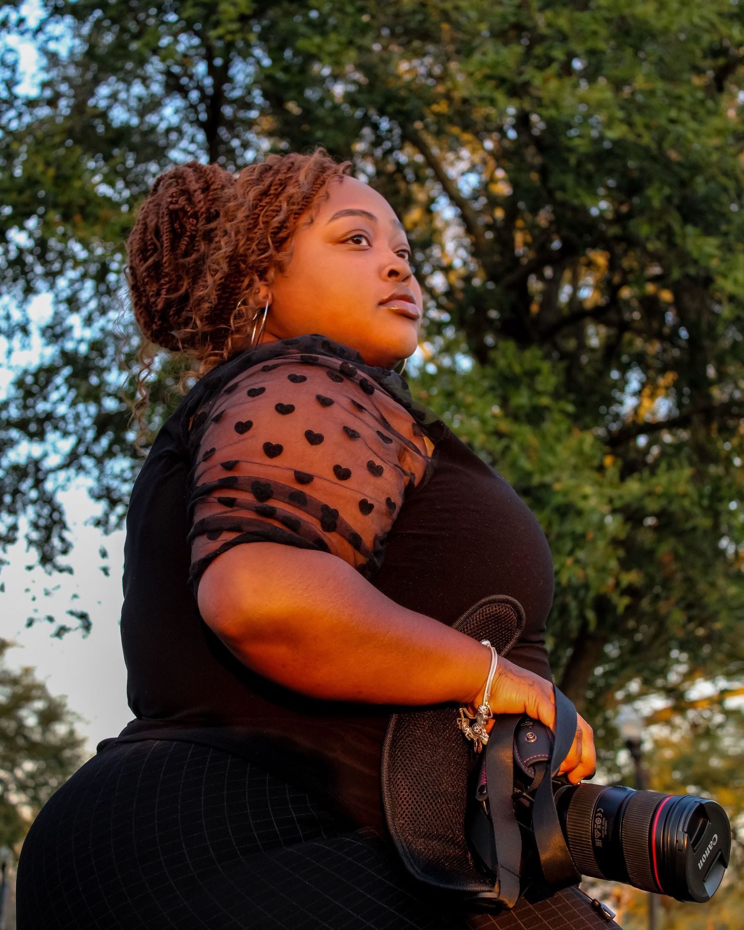 Professional photographer in polka dot top captures special moments at an outdoor event.