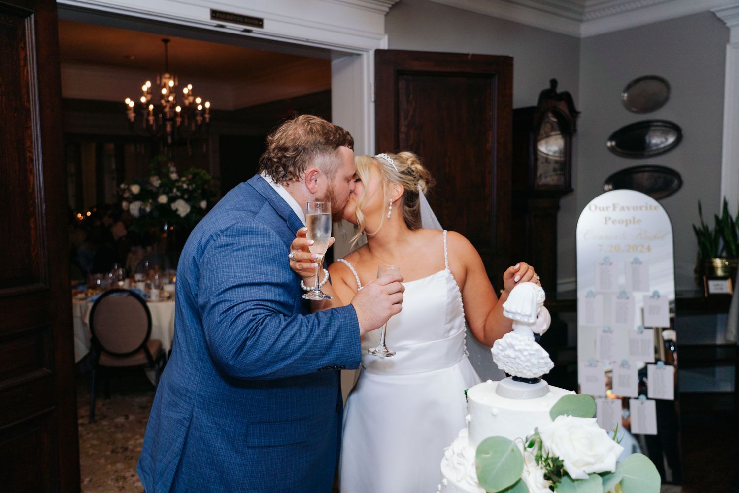 Elegant indoor wedding reception scene with chandelier and romantic lighting.