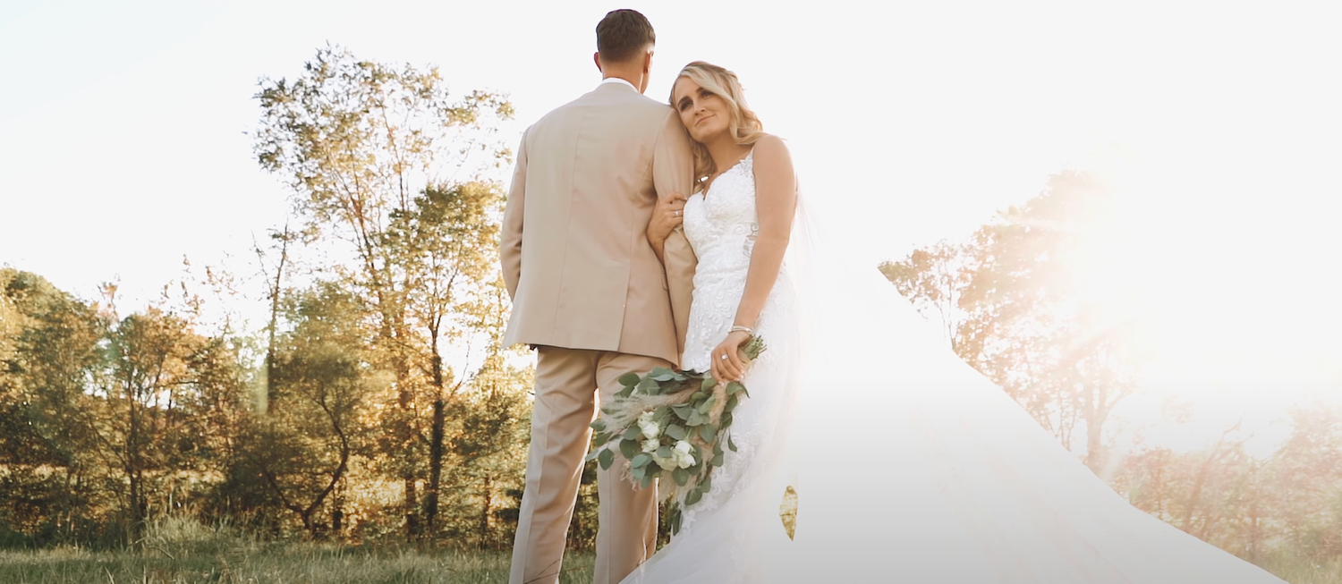 Romantic sunset wedding photos with couple walking through natural outdoor setting.