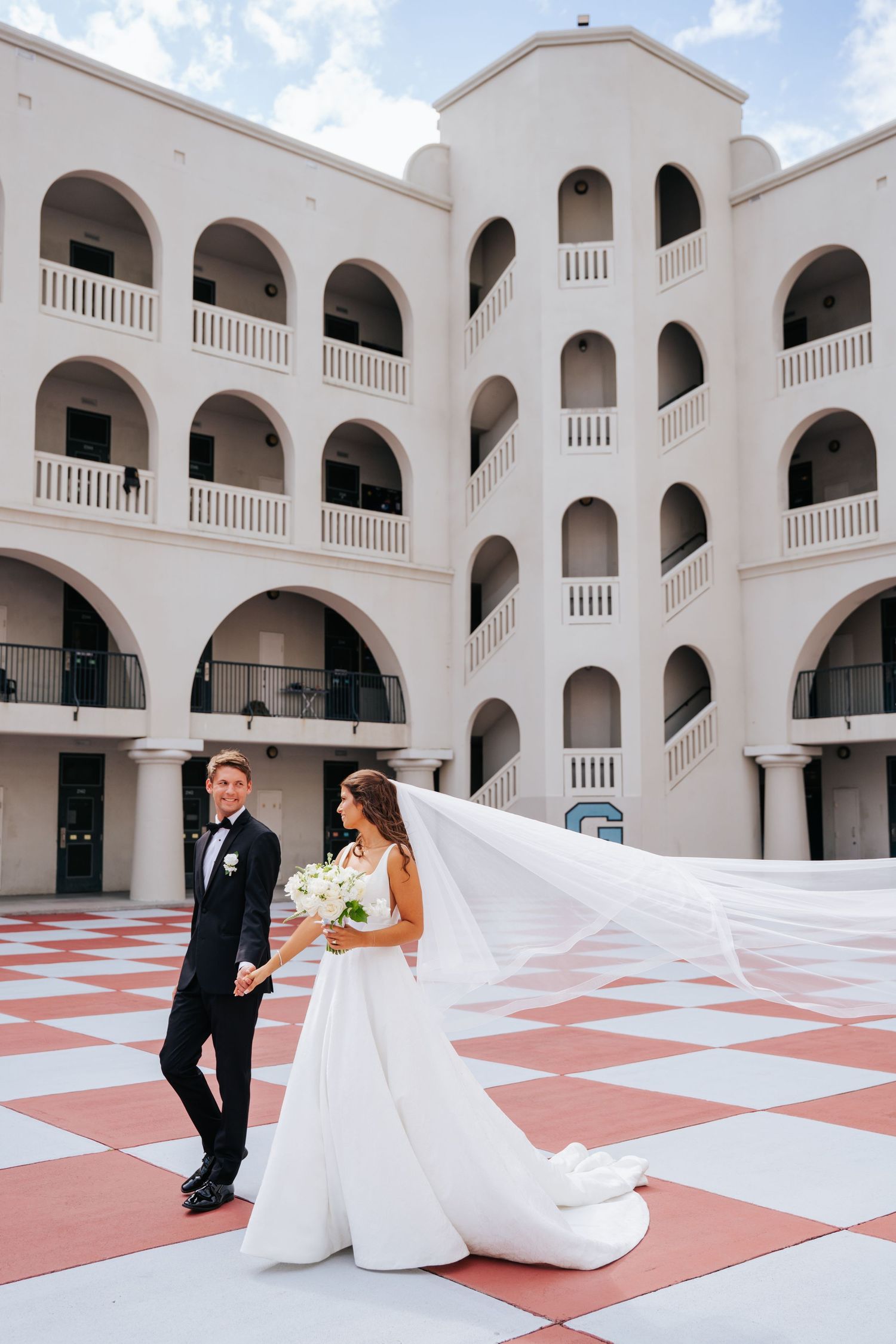 Wedding couple dances playfully on the Citadel's barracks.