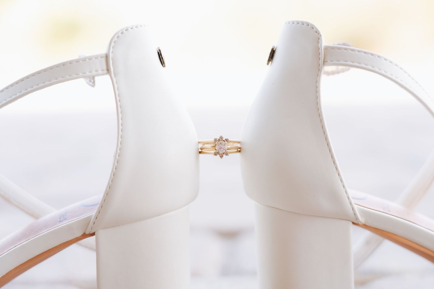 Close-up details of a white wedding dress with delicate lace and beading patterns.