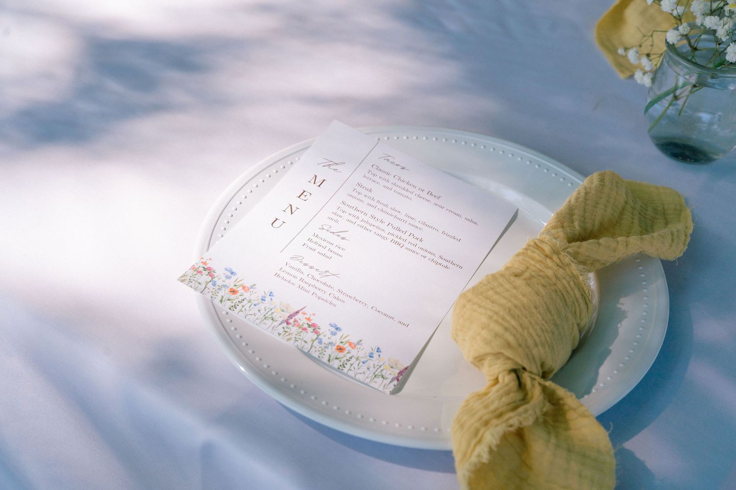 Soft focus wedding stationery and paper goods in dreamy natural lighting.