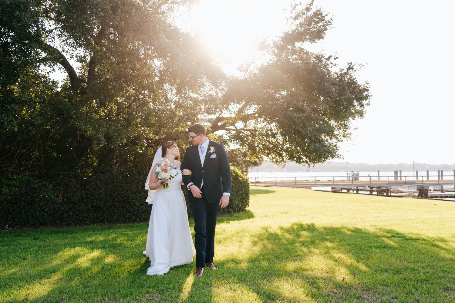 Golden hour wedding portraits taken in a scenic waterfront location.