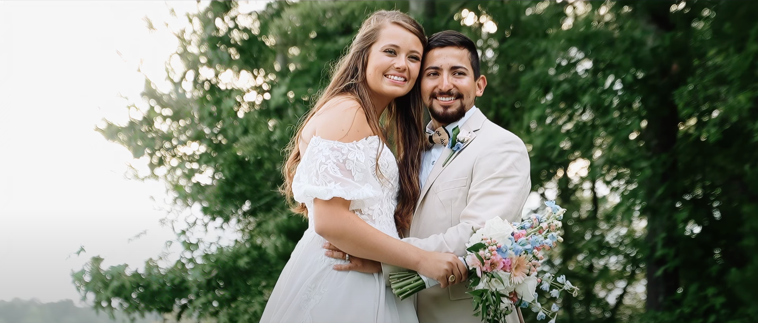 Wedding celebration in a lush green garden setting during summer.