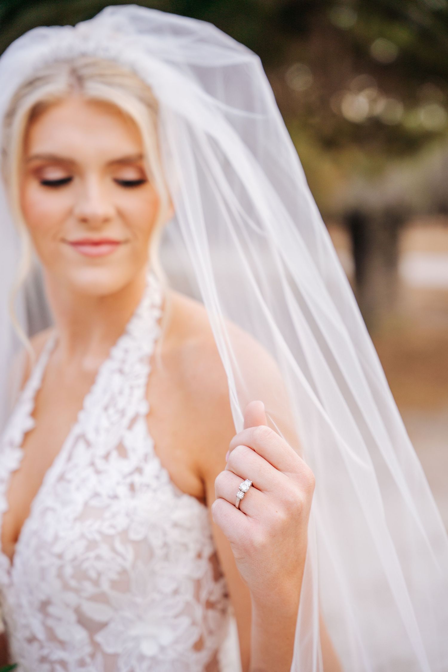 Close-up bridal portraits showing delicate lace veil details and elegant wedding dress in soft natural lighting.