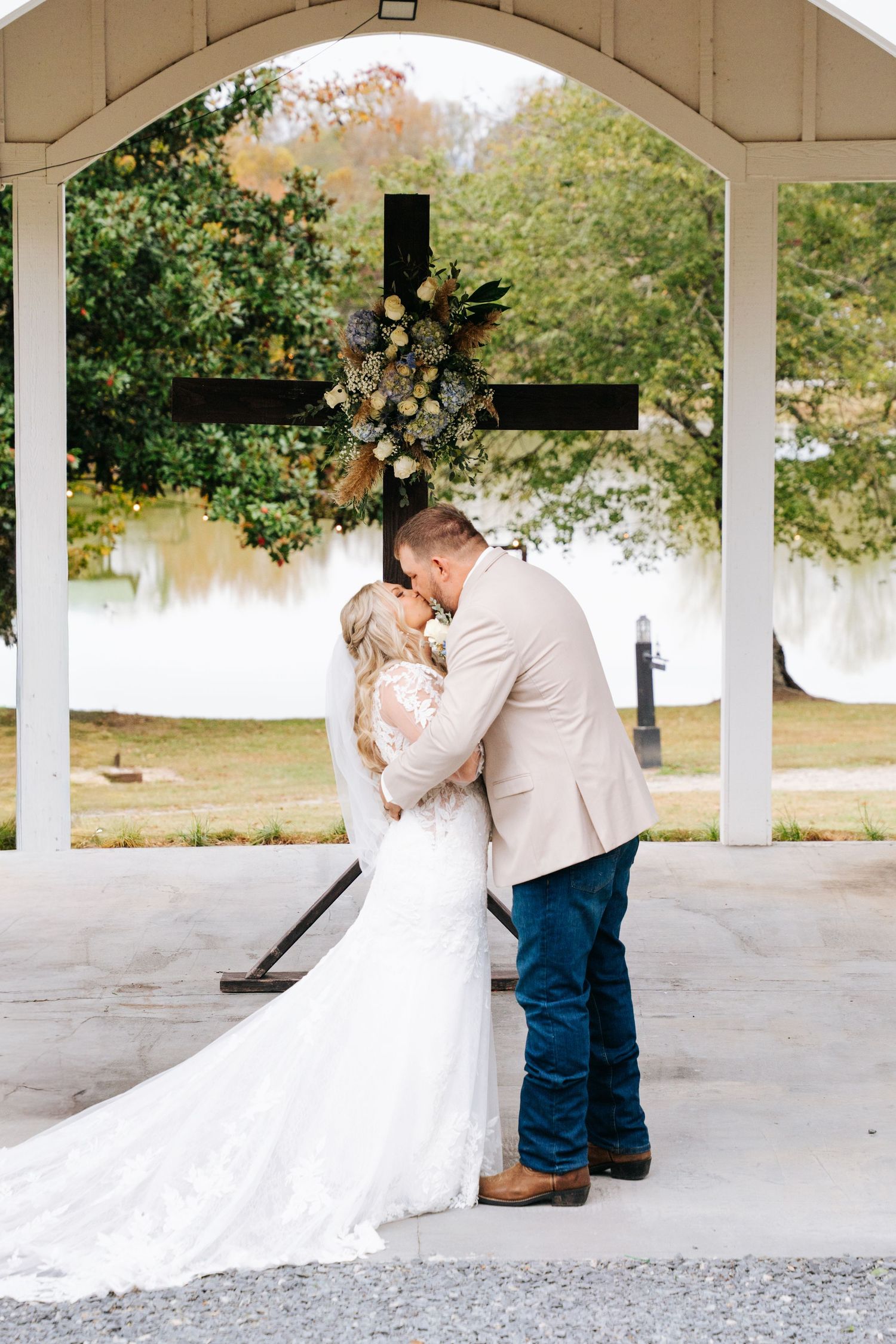 A romantic first look sequence between a couple in a white covered pavilion on their wedding day.
