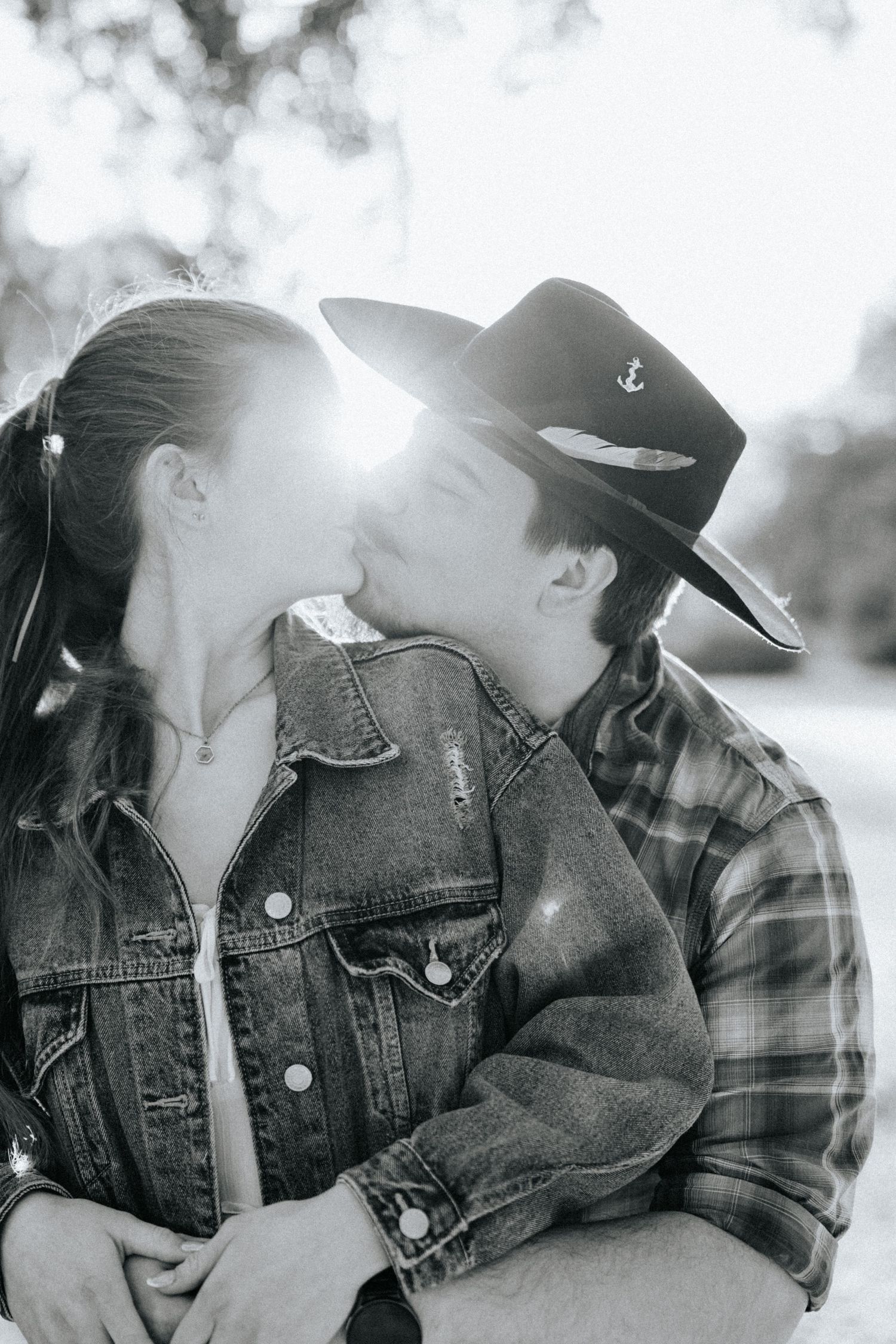 Black and white romantic photo series showing a couple in denim and casual wear sharing intimate moments.