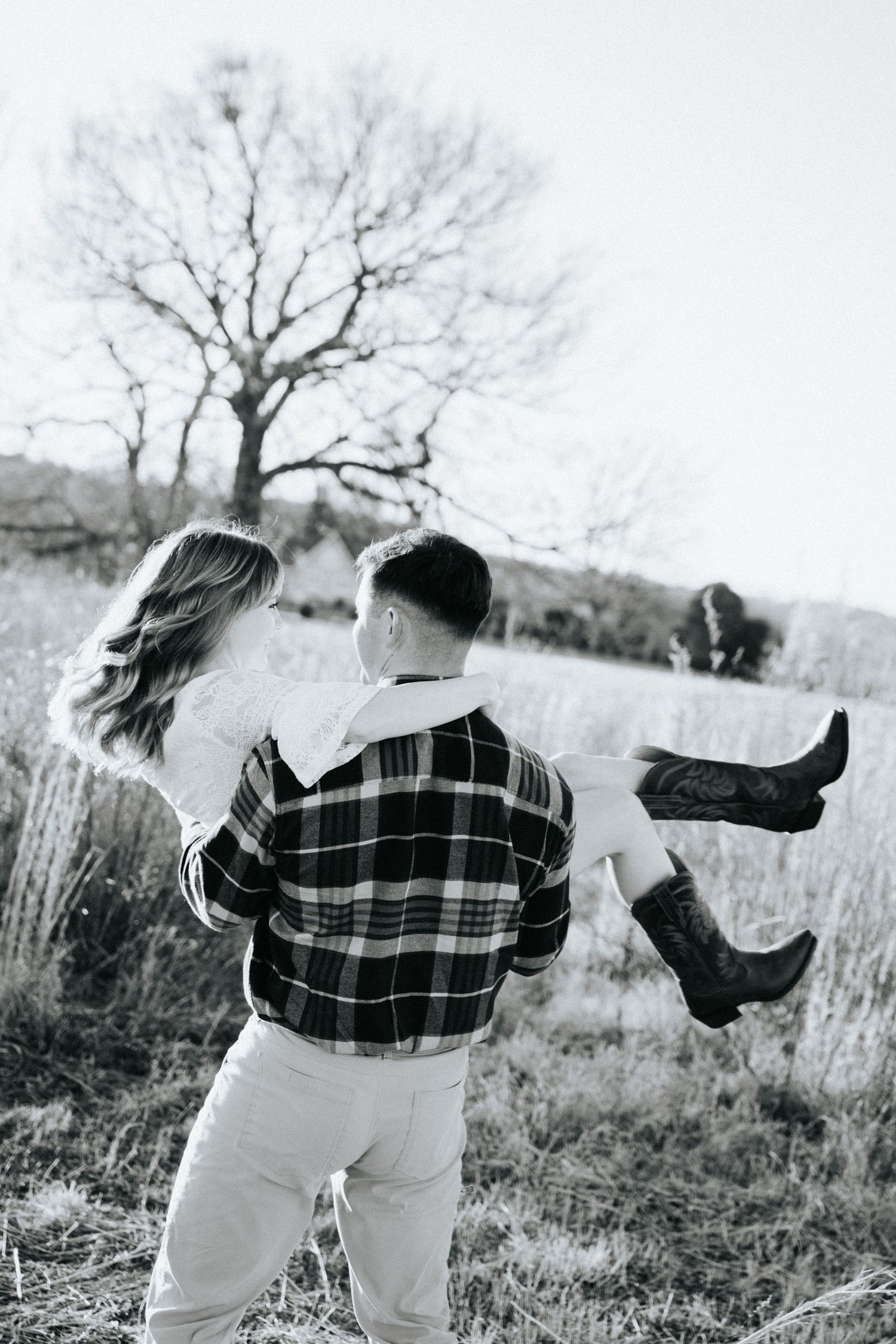 Black and white photo series showing a person in a plaid shirt and light pants throwing a hat in a field.