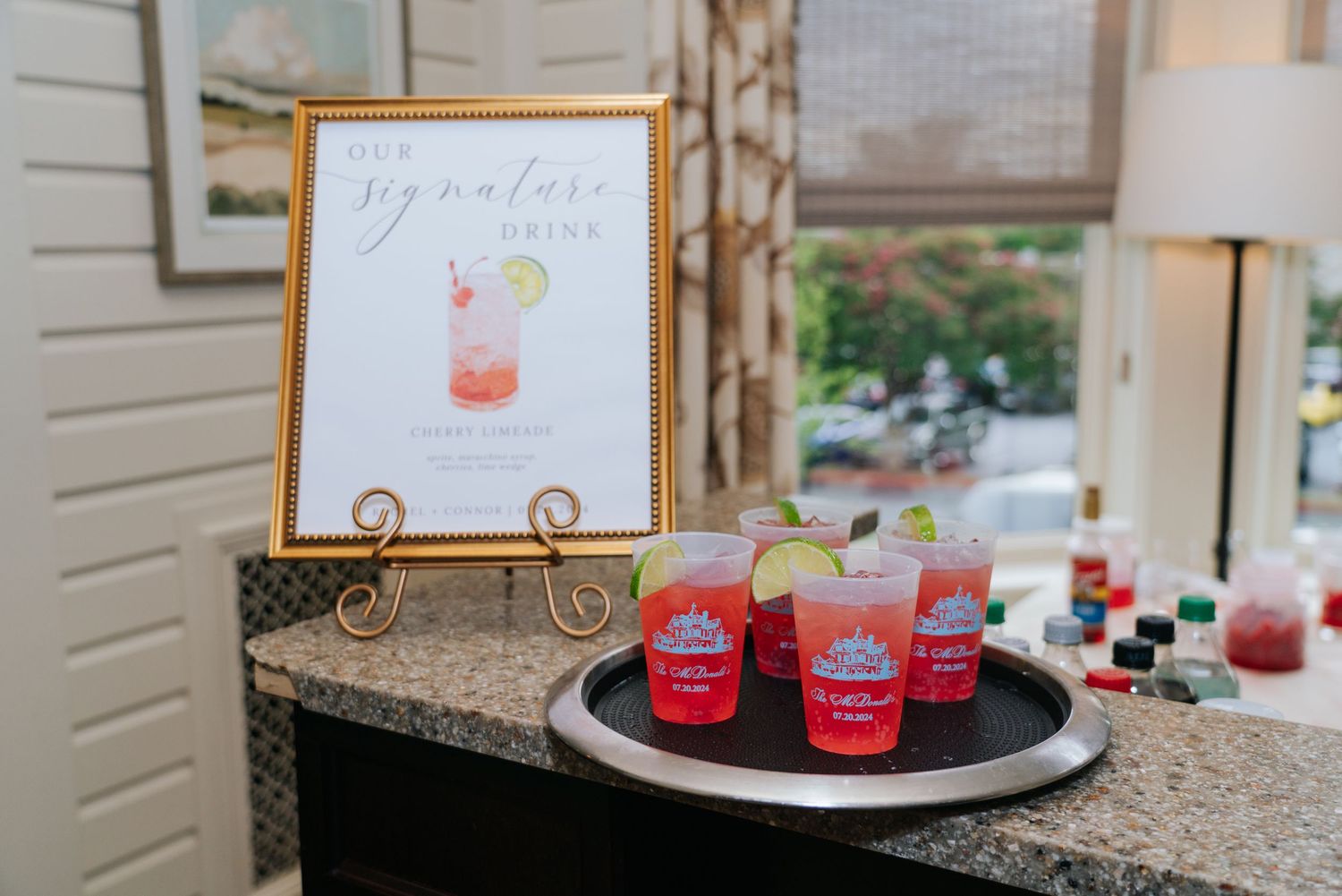 Wedding reception details with signature cocktails and decorative menu cards on display.